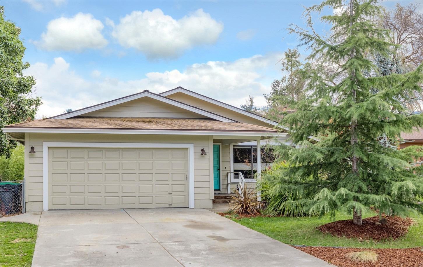 Get inside this cozy single level home. Walkable to restaurants, schools, parks and the library, this is an ideal option for a family or retirees. Kitchen and large master have direct access to the beautiful backyard, perfect for kids or a garden. The kitchen also opens to the living room, complete with fireplace and lofted ceiling. Part of the garage has been converted into a studio, great for an office, storage, or could easily be reconverted. Fantastic location, convenient to Medford, Ashland, Jacksonville and the rest of beautiful Southern Oregon. Washer, dryer and other appliances included. Video walkthrough available upon request.