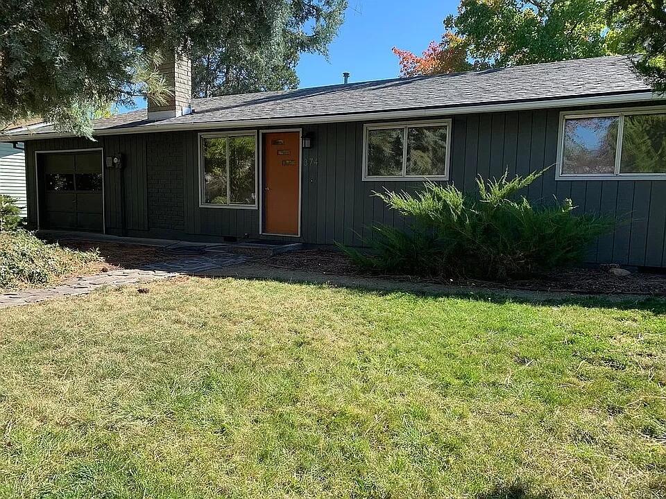Fabulous setting and views for this immaculate & comfortable single level home plus extra studio! You will love this wonderful neighborhood, only 3 blocks to Helman School with easy access to bike path, tennis courts, playground, dog park and community gardens, all just 1 mile to Ashland's Plaza.  Freshly painted inside and out, new lighting fixtures and laminate flooring make this home move-in ready. Open and sunny main living areas with wood burning fireplace in living room. 3 bedrooms, 1-1/2 baths in main home plus separate studio with full bath, kitchenette & separate entrance.  Incredible fenced rear yard with expansive lawn areas, apple, plum & apricot trees, raised garden beds & grape arbor, covered patio and views of Mt Ashland. Home and studio have previously rented for $1,950/month (combined). Main house is 1,036 SF, studio is 352 SF. Come fall in love this peaceful and idyllic setting and the lovely southern exposure! Attached one car garage for convenience and security.