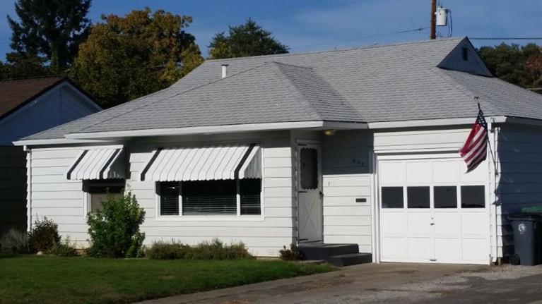 Fantastic lovingly maintained cottage with hardwood floors and yesteryear charm! Vinyl windows, siding and excellent for plan. There is an attached 1 car garage and super large detached shop/man cave and extra garage with alley access. This is perfect for entertaining or tinkering on toys. Well maintained yard with in-ground sprinklers front and back.
