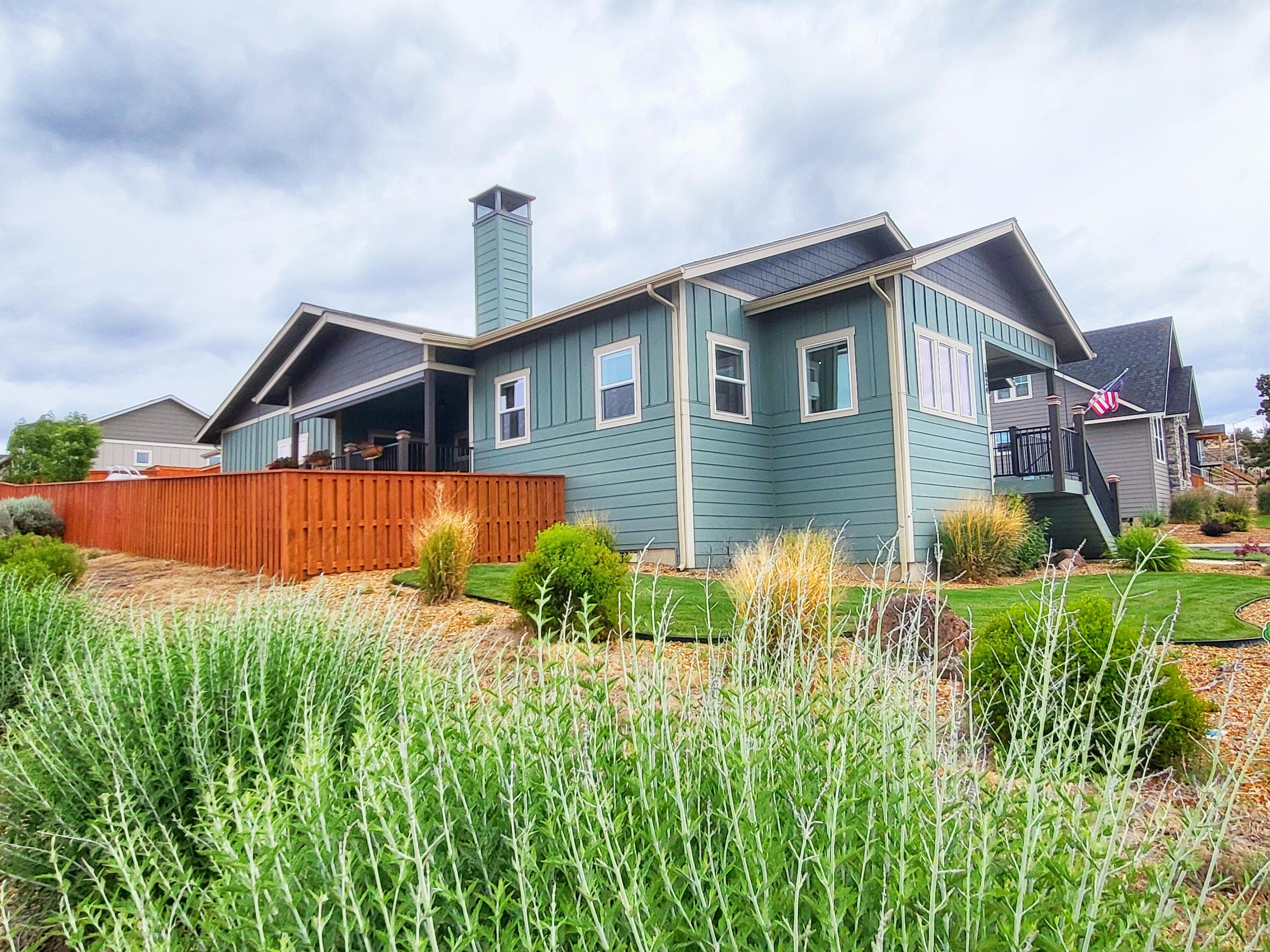 NEW PRICE!!!   One of the best buys out  there!  Perched on the hill in the desirable Yarrow subdivision, this stunning single-level Earth Advantage home offers breathtaking panoramic views. A welcoming front porch invites you to take in the scenery before stepping inside the foyer to a bright & open floorplan with stunning LVP flooring throughout, vaulted ceilings, wood burning stove, & Cascade mountain views. The chef's kitchen is a dream, featuring a massive 7 foot quartz island, perfect for entertaining. A versatile flex space is ideal for an office or craft area. Enjoy spectacular sunsets from the west facing 20x15 covered deck, complete with a remote control sun screen for year round comfort. Large RV parking area & a spacious 3 car garage with 220v & a 28ft deep 3rd bay for the toys or workbench. Located near Central Oregon's best recreation spots - fishing, lakes, trails & more - this home is a true gem! Don't miss this incredible opportunity!