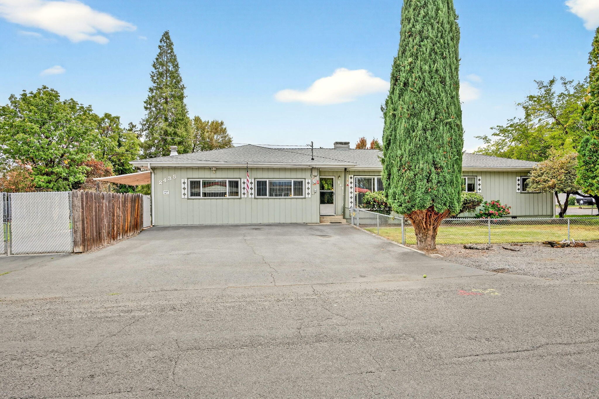 GOT TOYS?  This unique property is a dream come true!  Perfectly situated on a spacious 0.31-acre corner lot in a well-established neighborhood, this 4-bedroom, 2-bath home offers the ideal setup for those who need space to store, work, and play. There's paved parking for multiple vehicles, plus a 74-ft gated RV parking area, w/one automatic gate for added convenience. Multiple attached shop spaces with separate entrances, provide room for hobbies, storage, or projects of all kinds. Inside, you'll find brand new carpet throughout, new laundry vinyl flooring, remodeled kitchen w/pantry & eating bar, an indoor laundry room w/ample storage. Enjoy peace of mind w/a newer roof (installed 2023) & newer solar system, to help keep utility costs low. Outdoor features include a recently redone covered patio, dog run, storage shed & fully fenced yards w/sprinkler system. Conveniently located near Rogue X, shopping & local amenities, this property is a must-see for anyone w/big dreams & big toys!