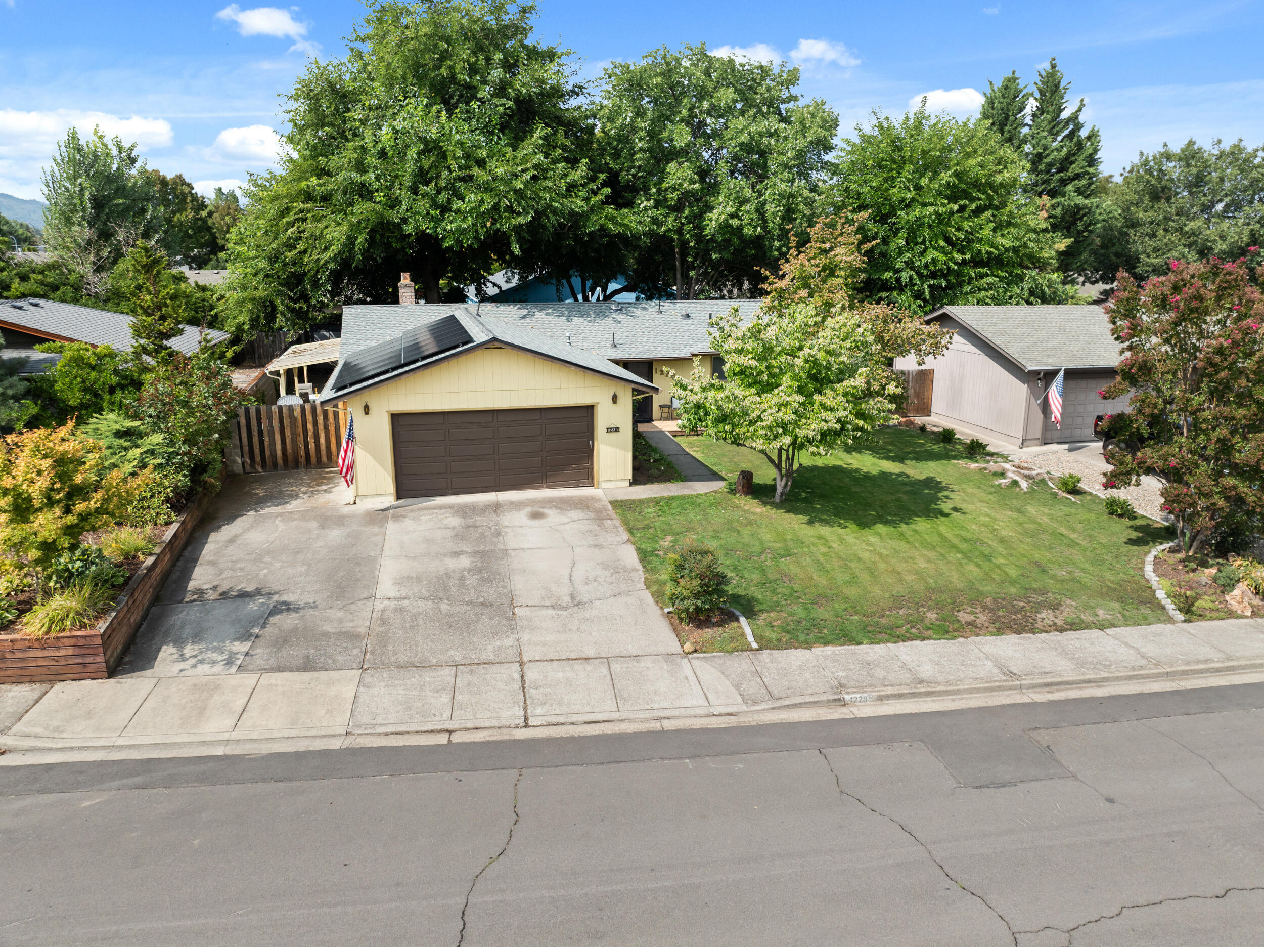 This single-level home has 3 beds and 2 baths and is located in a low traffic, pocket neighborhood in SW Medford. Sitting on a .20-acre lot with mature landscaping highlighted by a large, shaded backyard and covered patio. The home has seen some recent updates including HVAC, roof/solar, flooring, primary bath, and removal of a couple overhead cabinets to give a more open feel in the kitchen/dining/living room. There is an extra-large paved driveway that could possibly accommodate RV/boat parking. The current owners have created a flex space in the garage for additional square footage and storage, but the space could easily be converted to a shop or back to conventional garage space.
