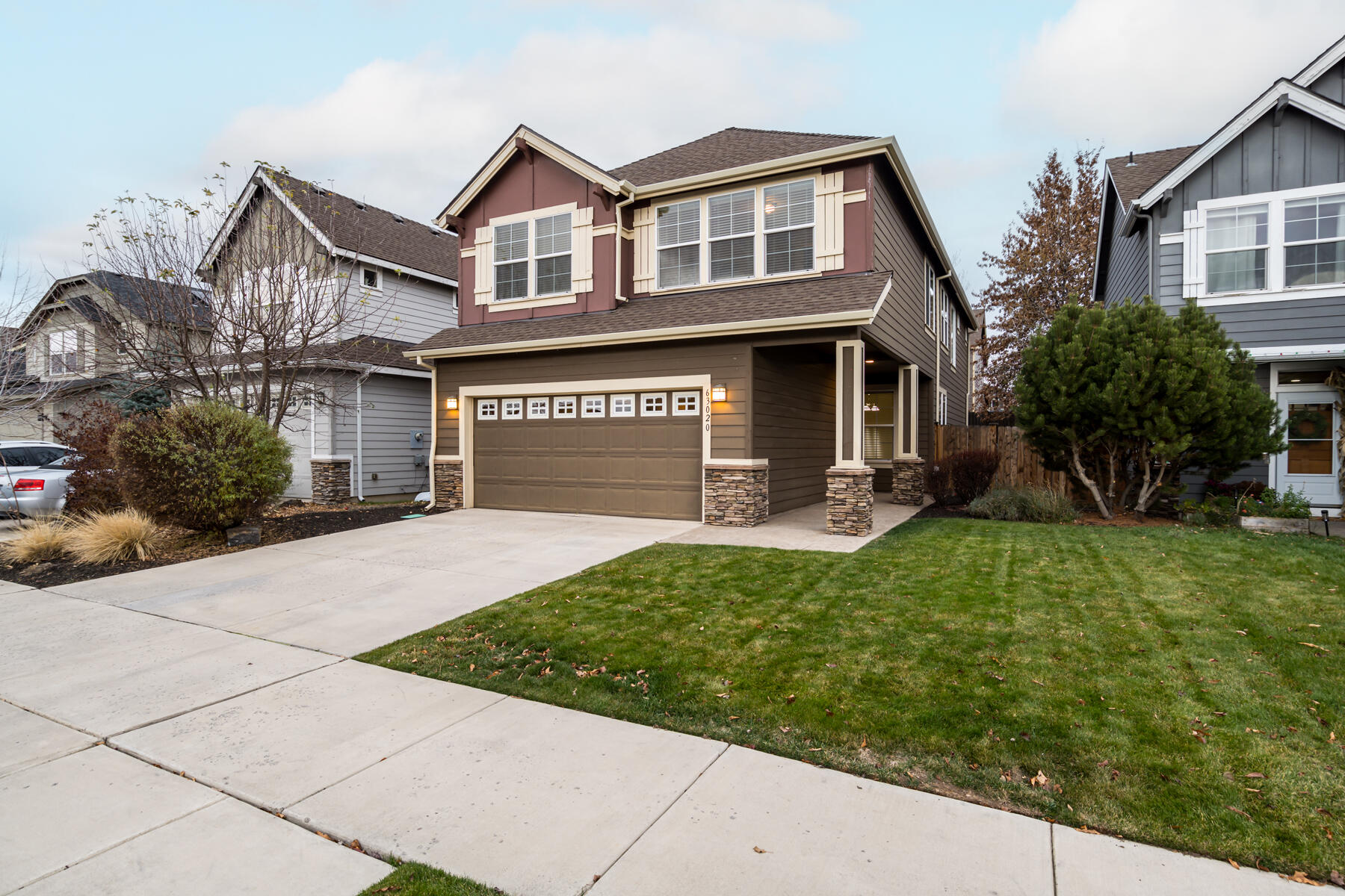 Built by Monticello Homes in a quiet NE Bend neighborhood, this well-constructed and well-maintained home sits just a stone's throw from 159-acre Pine Nursery Park. A thoughtful floor plan features arched doorways, a dedicated den/dining room, and an open living room and kitchen with gas fireplace and sliding door access to an expansive, completely-covered concrete patio perfect for year-round outdoor living. Upstairs, a split-bedroom layout offers privacy, with the primary suite separated on one side. The primary features vaulted ceilings, French doors, a double vanity, soaking tub, and spacious walk-in closet. A versatile loft space provides room for a home office or bonus area. Additional highlights include new carpet throughout, a powder room for guests, a second full bath with double vanity, and a private, fully-fenced backyard with space for raised garden beds. Super clean and move-in ready with no HOA and easy access to NE Butler Market Road. Less than 15 minutes to downtown.