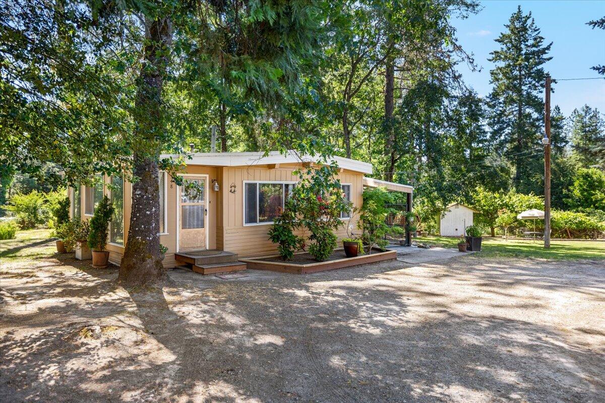 IMMACULATE 2 bed, 2 bath 1971 manufactured home on land—every surface updated! This cute and cozy home features brand-new carpet and flooring throughout. Nestled on a low-maintenance 1/5-acre lot with two wells, low taxes, and a detached insulated garage with 220 power plus an additional shed. Enjoy the convenience of being close to town and all amenities while still savoring the peaceful county feel. A fantastic opportunity for a move-in-ready, updated home with room to live simply and comfortably!