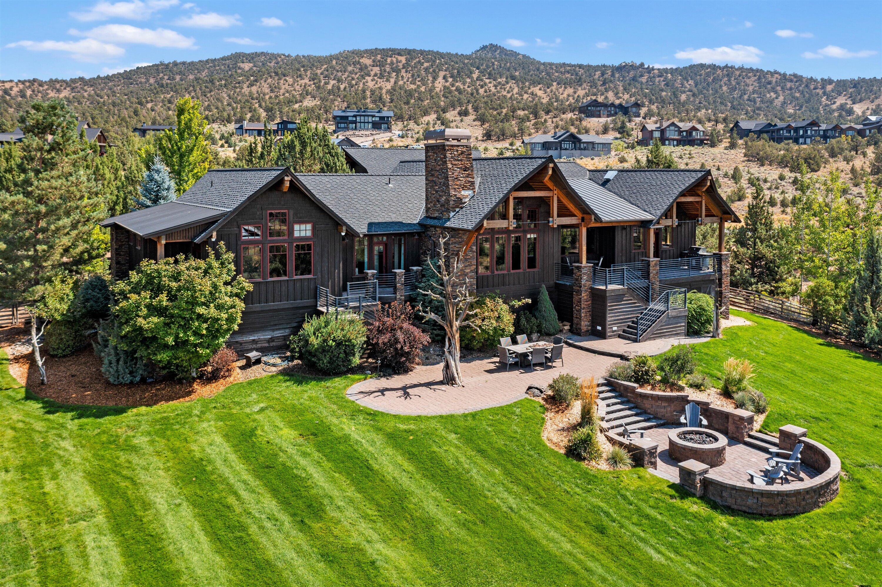 Enjoy all the benefits of Brasada Ranch - a gated destination resort community. This custom home boasts Cascade Mountain views on a most desirable property protected on 2 sides without neighbors. Featuring a sprawling lawn, patio & large built in gas fire pit.  A covered terrace runs along the back where you can enjoy al fresco dining and dramatic sunsets. Inside find voluminous ceilings, dramatic stone fireplace, open kitchen w/center island, large pantry & wine closet creating a perfect flow for entertaining. Split floorplan features 4 BR + office & 2nd story flex room. Owner's Suite; private terrace, over-sized walk-in closet, tile & stone shower w/ wood soaking tub. A long driveway, 3-car garage & wrap around porch wait to welcome you. With the right vision this home can become your stunning oasis.  Don't miss out on the chance to make this property your own.