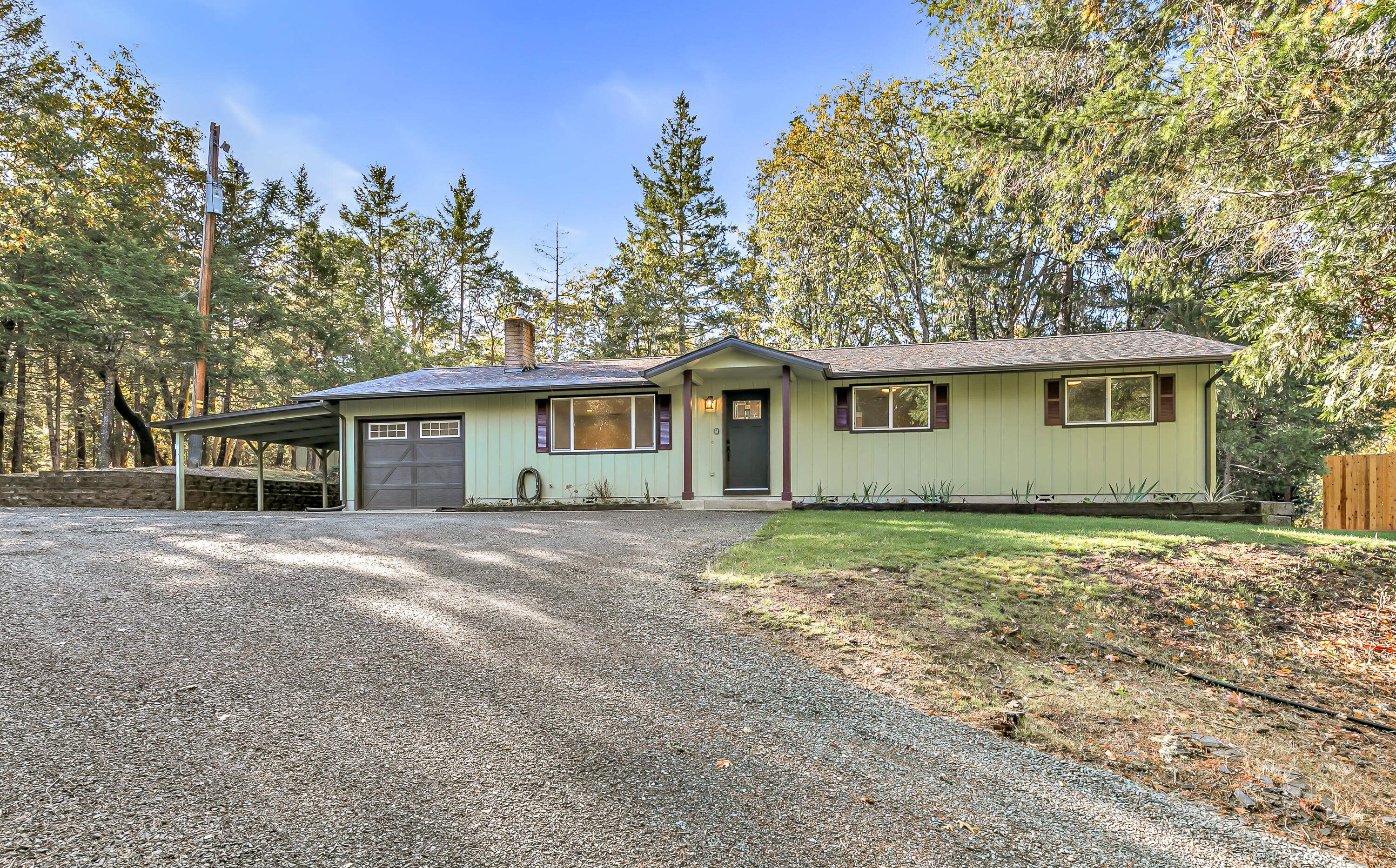 Seeking a cozy getaway in the woods? If so, this is the one for you! Remodeled inside and out, this single level charmer features 3 bedrooms, 2 full bathrooms, 1248 sq ft, open floor plan, newly refinished kitchen, new appliances, new bathrooms, new HVAC system, new roof, new gutters, new lighting, new interior/exterior paint, RV parking, single car garage (whole house fan installed within garage), attached carport, spacious deck, underground concrete 2000 gallon holding tank, new privacy fencing installed between neighbors, & much more! Large 0.93 acre lot is landscaped front and back w/ in ground sprinkler systems installed. Close proximity to both Merlin and Grants Pass as well! Enter into your living room, light a fire in your woodstove, and enjoy the ambiance a freshly remodeled home has to offer. Rare opportunity to find a property at this price point with so much to offer, so contact your agent today for a personal tour, before it's too late!