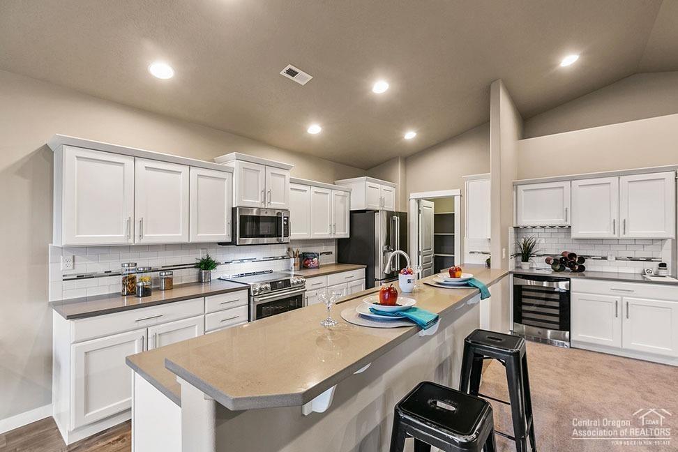 This 1800 Sq. Ft., single level Orchard plan is a home offering both space and comfort bordering the Deschutes National Forest. The open kitchen is a chef's dream, with counter space galore, plenty of cupboard storage, Costco sized pantry, and a breakfast bar. The expansive living room and adjoining dining area complete this eating and entertainment space. The large and private master suite boasts a dual vanity bathroom, separate shower and an enormous closet. Expected completion in December, photos are of a similar home.