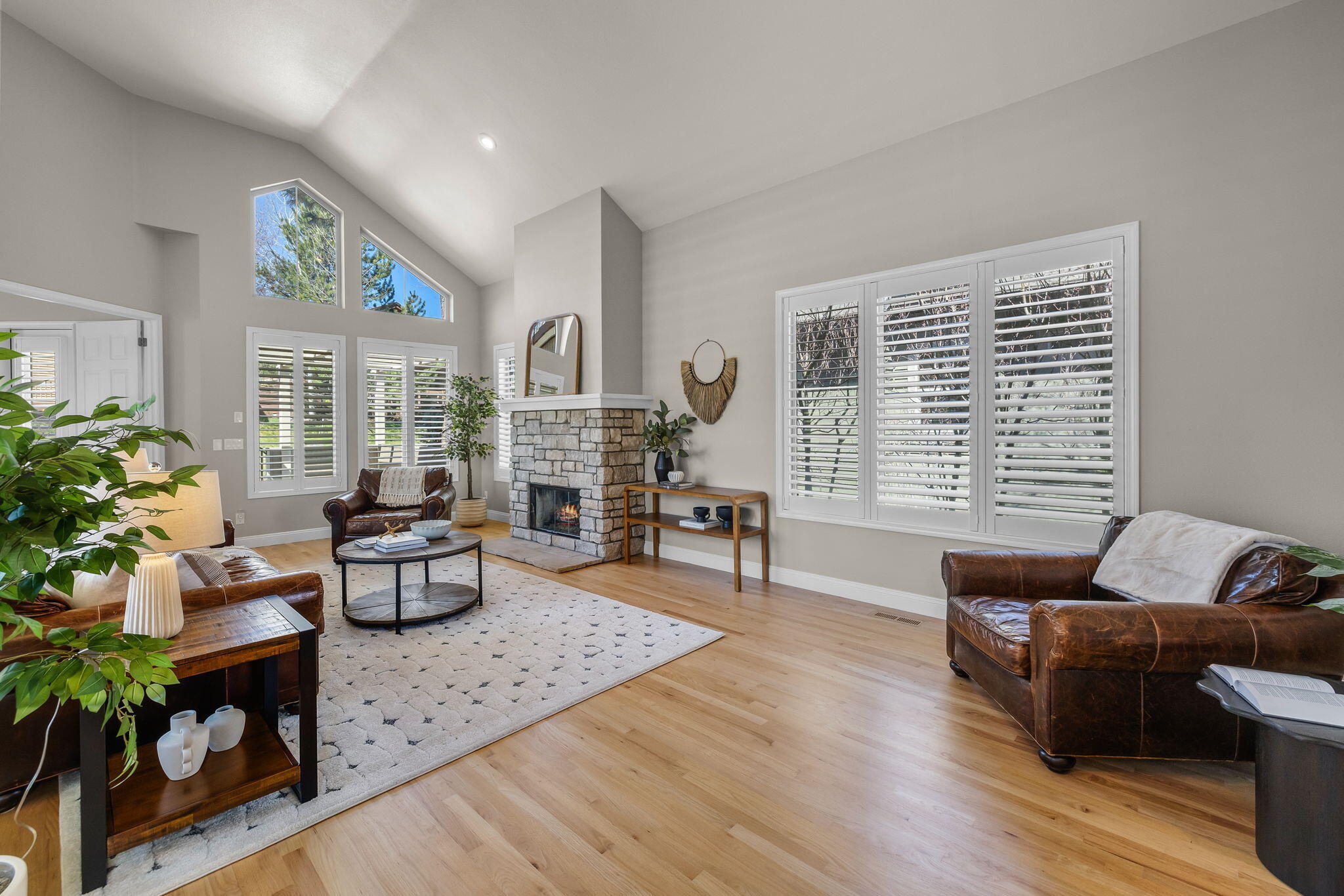 Beautifully remodeled single-level Broken Top home exudes modern elegance w/ a peaceful creek-side setting. Upon entry, the home greets you w/ a blend of sophisticated & welcoming interiors. The inviting great room, anchored by cozy fireplace, features vaulted ceilings & abundant windows, enhancing the home's connection to the outdoors, while a dedicated sitting area presents another comfy nook beside the fireplace. The dining area seamlessly connects the inviting living space, where plush seating areas surround 2nd stone-encased fireplace. This gathering space is ideal for intimate dinners or serene evenings. The kitchen is a chef's dream, w/ sleek cabinetry, subway tile & high-end appliances. Island/breakfast bar marks the heart of the home, where conversation flows as freely as the nearby stream. The primary suite's private courtyard provides a retreat to start your day or wind down under the stars. Each courtyard is placed to capture the views of the greenspaces, creek & waterfall