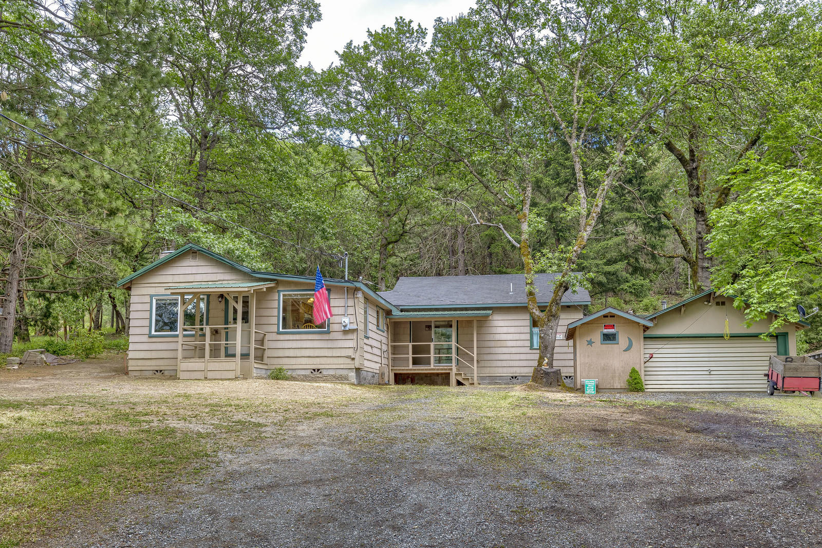 HOBBYIST'S DELIGHT! Cute & Clean 2 bed, 1 bath home on .54 acre lot with 2 car finished, heated garage, 3 additional outbuildings & a pole barn, all with power! Located just outside the Rogue River City Limits, the home, 1168 sq ft,  features a nice living room with fireplace, handy kitchen with bright dining area, inside laundry/mud room & Tempstar gas furnace. Enjoy the covered patio & back yard with fire pit and nice views. The 2 car garage is finished, has a certified woodstove & 2 nice long work benches with vices!  Sellers are also including the drill press, bench grinder & numerous hand tools, nicely organized on the walls. Ready for all of your projects!  All the other outbuildings have power, 2 are secure with locking doors and would make a great work space or storage.  Don't let this gem get away!  Is this YOUR new home?