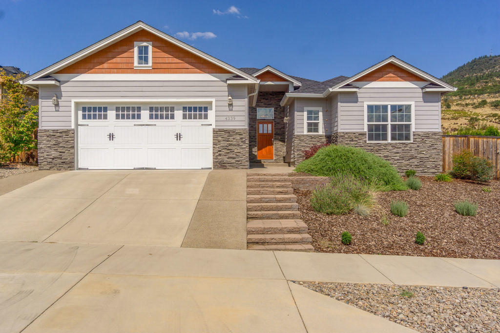 Roxy Ann views from this lovely craftsman single story home! Custom built Vista Pointe home w/open split floor plan. Spacious entry & high ceilings greet you as you enter; along w/gorgeous handscaped wood flooring. Open great room w/gas fireplace & tray ceiling is perfect for unwinding or entertaining. Open to kitchen w/eat-in breakfast bar & dining area. Gourmet kitchen features granite counters, glass tile backsplash & a walk in pantry. Master suite is spacious w/French doors to backyard, tray ceiling & ceiling fan. Master bath w/double vanity & walk in closet is a retreat w/garden tub, plus radiant tile flooring. 3 additional large bedrooms & a full bath, also a half bath. Covered backyard patio facing Roxy Ann is a great place to relax & entertain & also offers in ground sprinklers & lawn area. Beautiful neighborhood too!
