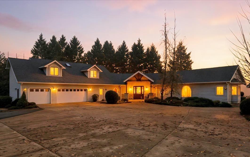 Discover this immaculate 1999 custom built, 3-bed, 3-bath home offering over 2,800 sq ft of updated, turnkey living.  Situated atop a private hill, the residence offers stunning panoramic views while maintaining complete privacy.  Main level features a gourmet kitchen with custom cabinetry & a built-in wine bar, all flowing into a spacious living area with grand vaulted ceilings. Main-floor primary suite includes a sitting area, patio access to enjoy the views, & a large ensuite with soaking tub & walk-in closet. Two guest bedrooms with dormer windows share a bathroom on the second level, offering a private space for visitors.  Massive 3-car garage, an RV barn, a 20 x32 garage for a boat or ATVs, & a shed, it's ready for a variety of uses. Recent upgrades, including a new roof, ensure this property is move-in ready.  As a bonus, this property includes $1815/month cell tower lease income. Towers on the perimeter of the property, hidden from view of the residence.