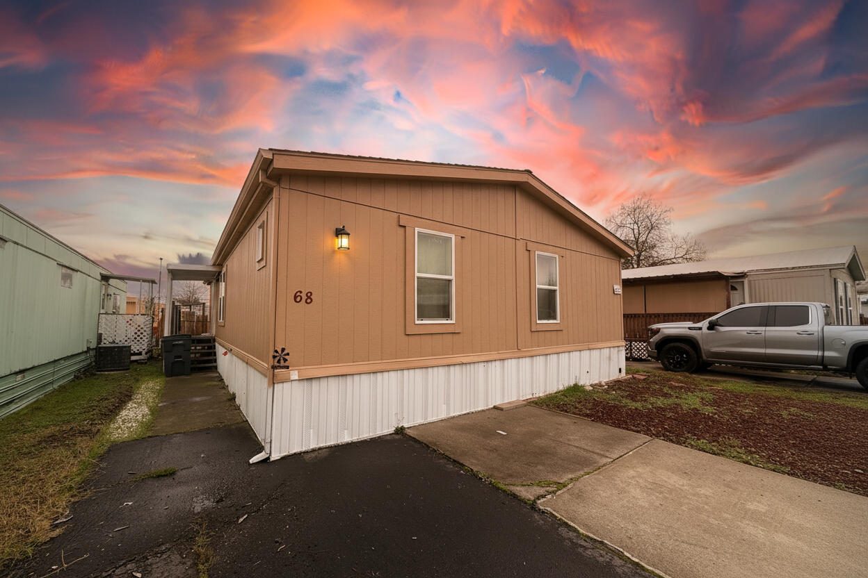 Move-in ready 3-bedroom, 2-bath double-wide home in a family-friendly park!  This home feels bright and spacious with its high vaulted ceilings and open layout. The split floor plan offers great privacy, with the primary bedroom separated from the other rooms. Enjoy beautiful luxury laminate flooring throughout (installed 2 years ago) and fresh interior paint from last year for a clean, updated feel.
The kitchen offers great space for anyone who loves to cook, featuring plenty of cabinetry for storage; newer dishwasher. The primary suite includes a walk-in closet and an updated bathroom. You'll also appreciate the fully fenced yard, perfect for pets or outdoor relaxing, plus a convenient laundry room. A well-cared-for home at an affordable price—come see it today!