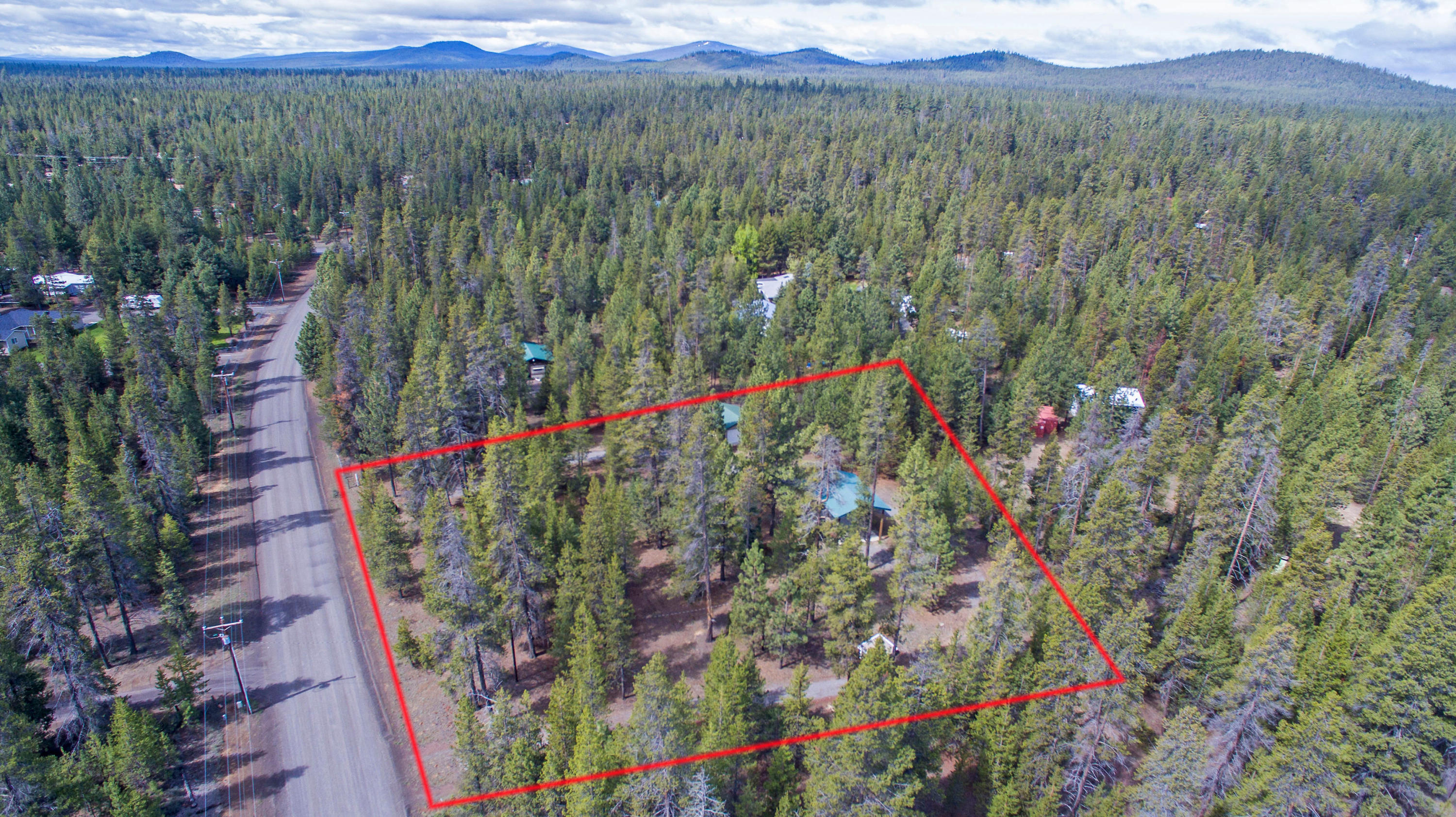 1.1 acres of privacy with beautiful ponderosa and spruce pines in La Pine, ready your RV and your dream home plans.  This lot has plenty of room for all your toys and already has electricity to a 480 foot dream shop, circular gravel drive, standard septic, well pump house with new 86 gallon pressure tank, and a pull thru, full hook-up, open-sided RV barn with metal roof, 20/30/50 AMP electric, water, and dump.  Call your favorite agent for a personal showing!