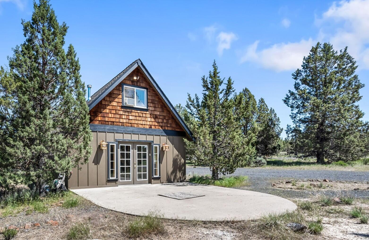 A unique cabin getaway located in the heart of Central Oregon. As you step inside you're greeted by an open living space w/an abundance of natural light that illuminates the entire downstairs living area & kitchen. A warm & inviting atmosphere ftring a cozy corner gas burning fireplace w/stacked stone, hearth, & mantle. Slate flooring in the lower level + recessed can lighting. Kitchen ftrs a small breakfast bar, quartz counters, plenty of cabinetry & all appliances included. Full bath on the main w/quartz counters, tile floors, & step in corner shower. Upstairs you'll find two sleeping areas/rooms w/ a unique cabin feel; cozy carpet & wood paneled ceilings. 1500 gallon cistern under the pump house. Water tank stays for hauling water. Gas tankless water heater, 400 amp service, oversized septic, leased propane tank, picnic table + firepit area, cadet heaters, window A/C units, fresh exterior paint, BLM access, plans for shop, no w/d hookups. Bring your toys & adventure gear! RV access!