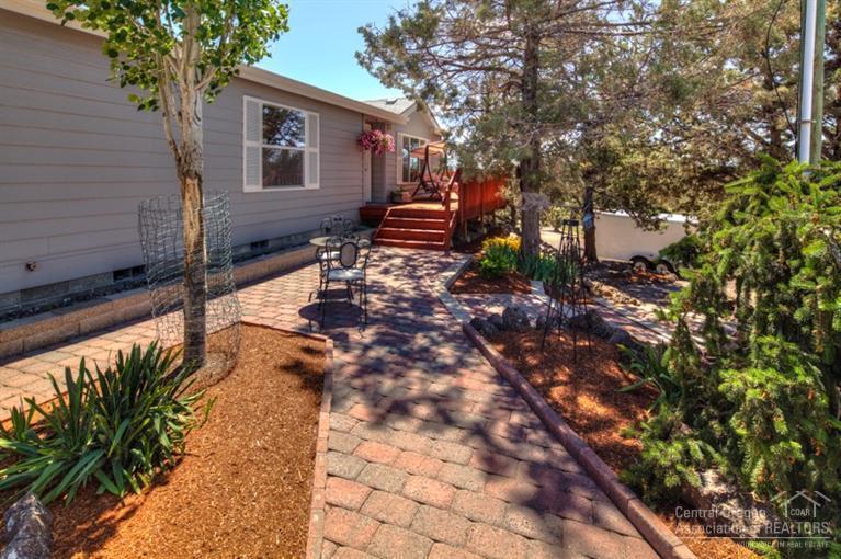 Immaculate property from corner to corner! Amazing Mountain Views & evening sunsets from the wrap around deck. Comfortable floor plan w/spacious kitchen, mud room & open living area, private Master Suite. Forced air heat, Central Air. Fenced yard & garden area w/water features, sprinkler system. Oversized dbl car garage w/openers & shop area. RV cleanout, prepped for 30x40 shop. Must See!