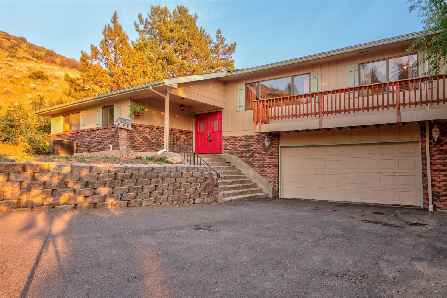 Welcome home to this mountainside hideaway. There's a hot tub with views over the snow-covered yard or entertain on the wrap-around porch where you can soak up the sunshine throughout summer and take in views of Klamath. The two-level layout is spacious with three good-sized bedrooms and two bathrooms, plus plenty of living space. A welcoming tiled entrance foyer leads inside to find lots of windows allowing an abundance of natural light to fill the home.There is a well-equipped kitchen and dining area, plus two living rooms to enjoy along with a wood-burning fireplace for those cold winter nights. An oversized two-car garage and plenty of storage throughout are just some of the extra features on offer. This charming home is set at the end of a dead-end street within the Roosevelt school district. There is a trail at the end of the street that leads in the heart of the surrounding landscape.