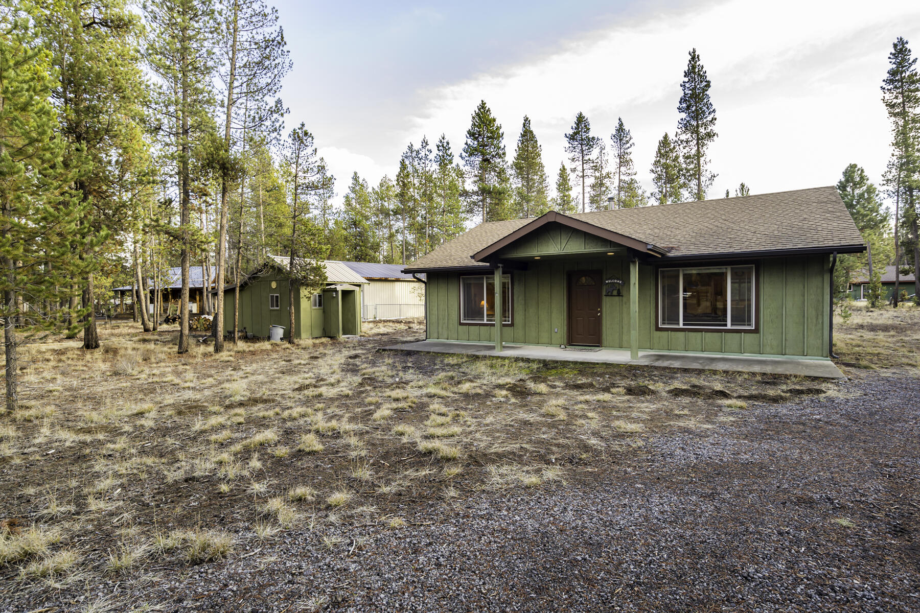 Discover the perfect cabin getaway in the heart of Central Oregon! This fully furnished 2bedroom and 1 bath home in Sun Country Estates offers a peaceful retreat with all the amenities for comfortable living. Inside, the open-concept design features a cozy living area with vaulted ceilings, a wood-burning stove and open to the kitchen with plenty of storage.  Set on a level on acre lot, the outdoor space is ready for your vision. Bunkhouse for extra guest or storage. 24 by 30 shop ready for all your projects.  Ideally located just minutes from the Big Deschutes River, this property invites you to enjoy kayaking, skiing, fishing, or quiet riverside strolls. Experience the charm of cabin living while being close to all the outdoor recreation and amenities that Central Oregon has to offer.