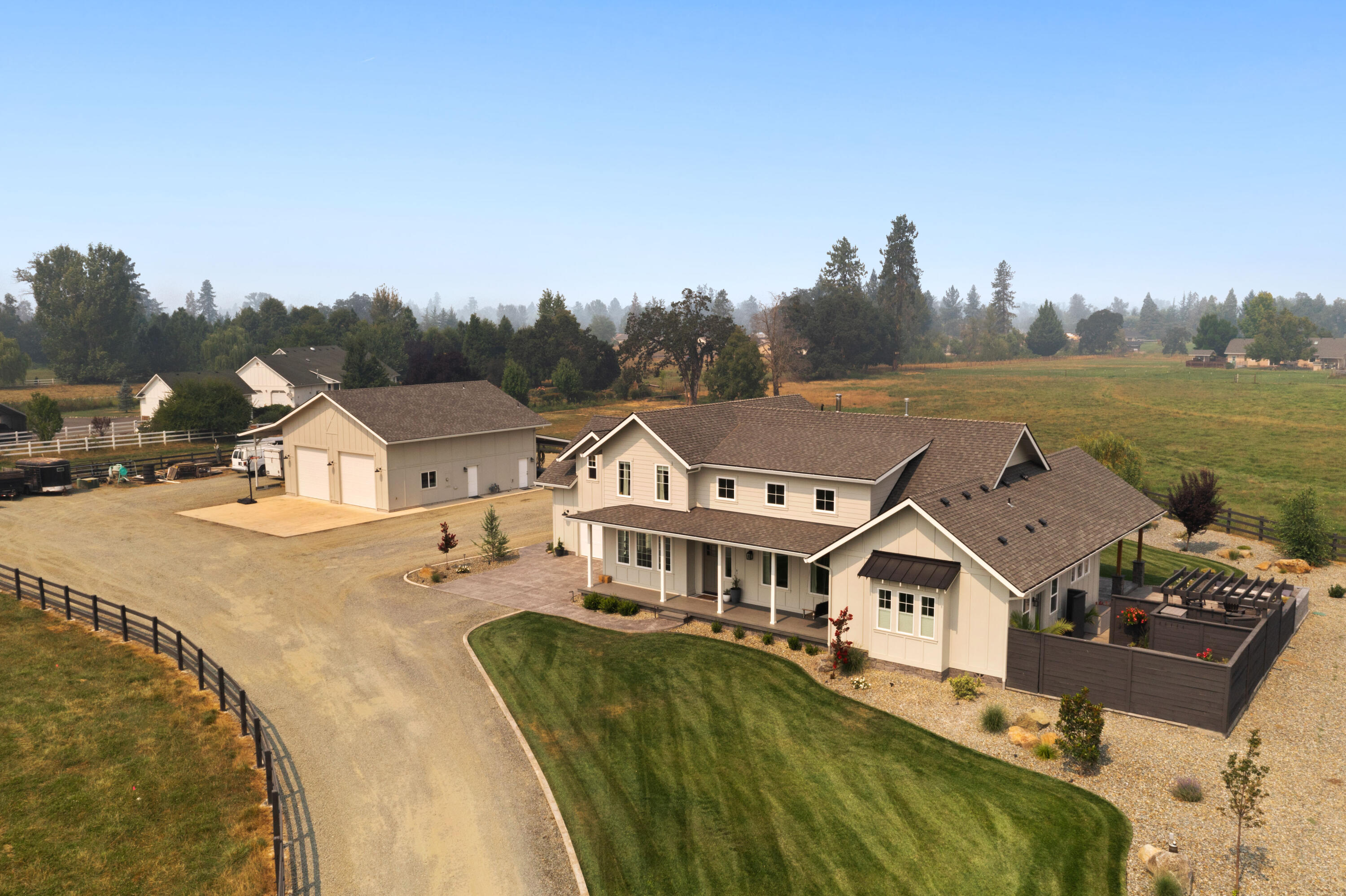 Stunning farm house custom built by a reputable local builder, Ross Meade! On fully irrigated 4.97 acres. Featuring 3425 sq ft, 4 bdrm, 2.5 bath energy efficient home. Well-designed entry into the open bright living room w/wood burning fireplace and picturesque windows. Spacious dining room, vaulted kitchen w/large island, breakfast nook, gas cook top, Quartzite countertops and stainless steel appliances. Massive pantry and oversized mud/laundry room. The master is a dream for all w/a jetted tub, massive walk in closet and magnificent step in tile shower. Eye catching covered back patio w/a cozy gas fireplace and a built in outdoor kitchen. A dream 2136 sq ft heated shop, w/a full bath, tankless water heater and upstairs bdrm. Bring your livestock and get the most use out of the fenced pasture. Room for all your toys w/covered RV parking.  Mature custom landscaping & high producing well. All information is deemed reliable but not verified.
