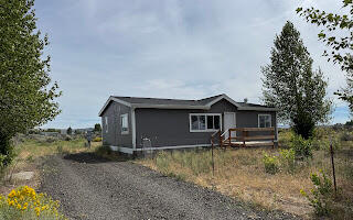 Updated double-wide home on spacious, shaded lot - Move In Ready!!  
Nestled on a level .31 acre lot, this beautifully remodeled double-wide manufactured home offers both comfort and potential.  With 3 bedrooms, 2 full baths, and thoughtful updates throughout, this property is ideal for anyone seeking peace, space, and a fresh start.  Step inside to find a refreshed home with new appliances, fresh interior and exterior paint, and a new roof ensuring peace of mind for years to come.  Relax outdoors on the newly built front porch, perfect for enjoying your morning coffee or the evening breeze.   This lot also has mature shade trees not only to enhance privacy and beauty, but to also create a tranquil atmosphere with their gentle rustling sounds.  Worth looking at!