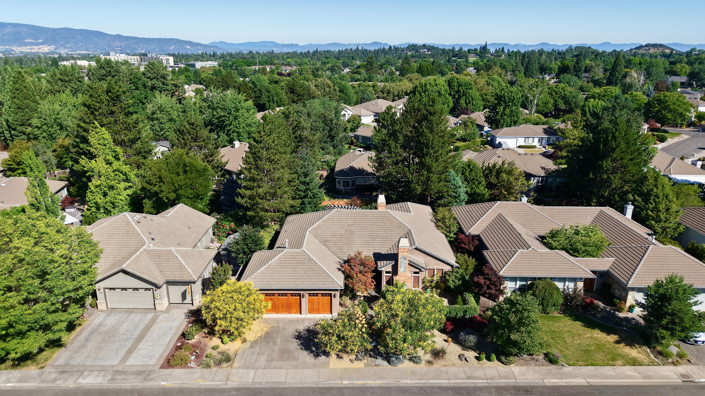 Exquisite Pagnini-built 3 bed, 2 bath home on a beautifully landscaped .24-acre lot in East Medford. With 2,896 sq ft of single-level living, this home blends timeless craftsmanship with comfort and style. Soaring beamed ceilings, numerous windows, and an open floor plan create a warm and inviting atmosphere. Enjoy hardwood, tile and carpeted flooring, two gas fireplaces, and amazing built-ins throughout. The gourmet kitchen features a large center island with gas cooking, granite countertops, an eating bar, windowed nook, and excellent cabinet space. The luxurious primary suite offers vaulted ceilings, dual vanities, a jetted tub, shower, walk-in closet, and a cozy sitting or desk area. Outside, the private backyard oasis includes mature landscaping, a water feature, and serene mountain and territorial views. Attached 3-car garage. Located near golf, shopping, medical, and restaurants—this home has it all!