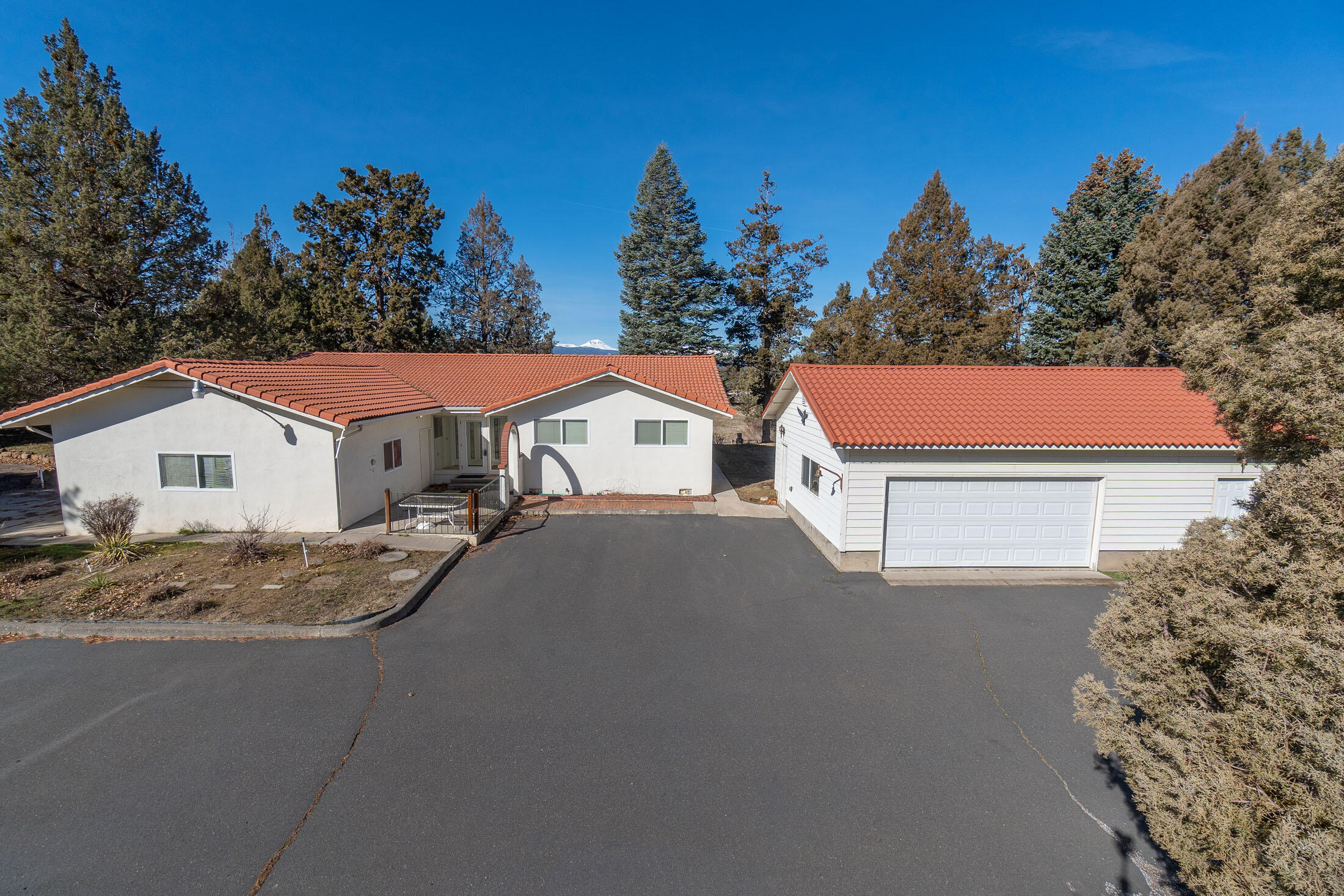 Superb Location just minutes from Tumalo and Bend!  Part of the property abuts the Old Bend-Red Hwy, making this horse property a quintessential embodiment of Oregon living. Enjoy the proximity to Tumalo State Park and a variety of dining and shopping options, offering a harmonious balance of convenience and serenity. This remarkable property encompasses a spacious 1798sqft first floor ranch-style home, boasting 4 bedrooms and 3.5 bathrooms.  Revel in the picturesque mountain views visible from the living room and rear deck, adding to the allure of the property. Additionally, the 576sqft finished basement, accompanied by a covered patio, offers a versatile space ideal for entertaining guests or a separate guest quarters.Spanning across 9.09 acres, the property features a fenced area suitable for livestock and 7 acres of irrigated land. Other outdoor amenities include  a detached 2-car garage with shop, a 52X48 barn equipped with numerous stalls, and an additional 1476 Sqft RV garage.