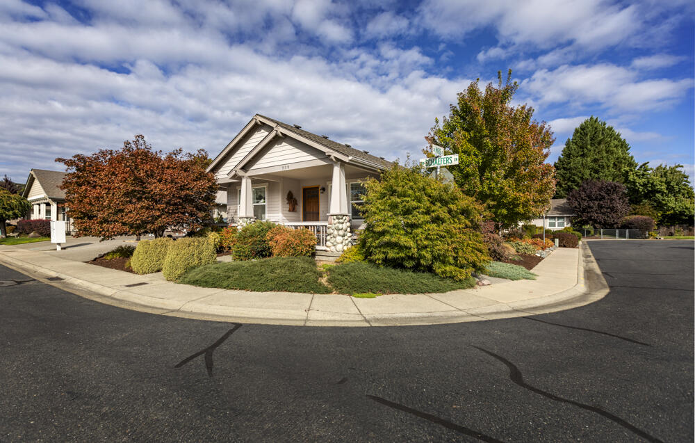 Beautiful, well maintained corner lot home in Schaeffer Estates, 55+ community.  Very sought after neighborhood. Two Bedrooms and TWO Bathrooms plus an additional office space/livingroom/family space. Open floor plan with many upgrades. Large custom Walk in accessible shower and added hand rails. Wheel chair accessible Ramp in garage to home. Some custom flooring. Nice cabinets, accents and light fixtures. Double paned windows throughout. Oversized two car garage with shop area, private back yard, wonderfully landscaped. Low Maintenance and private. There is space to park your RV and or toy in the common area Schaeffers Estates provides for owners. Best neighbors in town. Close to Rogue River , parks and downtown. Safe clean beautiful neighborhood - These do not become available often ! Come take a look- easy showings -VACANT  OPEN HOUSE  Dec. 3rd 12-4 pm ...Come on by!