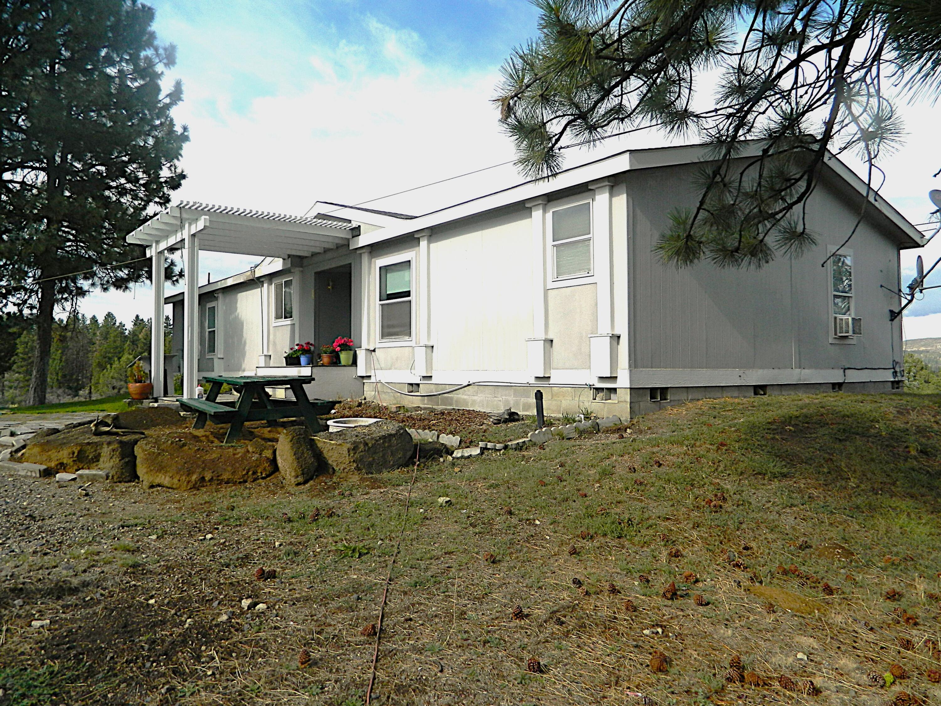 If you are looking for peace and serenity, look no further. This 3 bedroom 2 bath home sits on 2.44 acres overlooking the mountains has 1782 sq ft of living. It has a very open floor plan and split floor plan. Among other things, there is a wood burning fireplace for those wet chilly nights. Along with the 3 bedrooms, there is a separate office directly adjacent to the primary bedroom. The kitchen has plenty of storage including a good sized pantry and an island for an extra prepping area. the secondary bedrooms are good sized. The primary bath has a large garden tub, double sinks and separate shower. Main bath is equipped with double sinks as well. There is a separate garage with an attached carport on it and don't leave out the greenhouse so you can get a start on your garden ahead of the early freezes