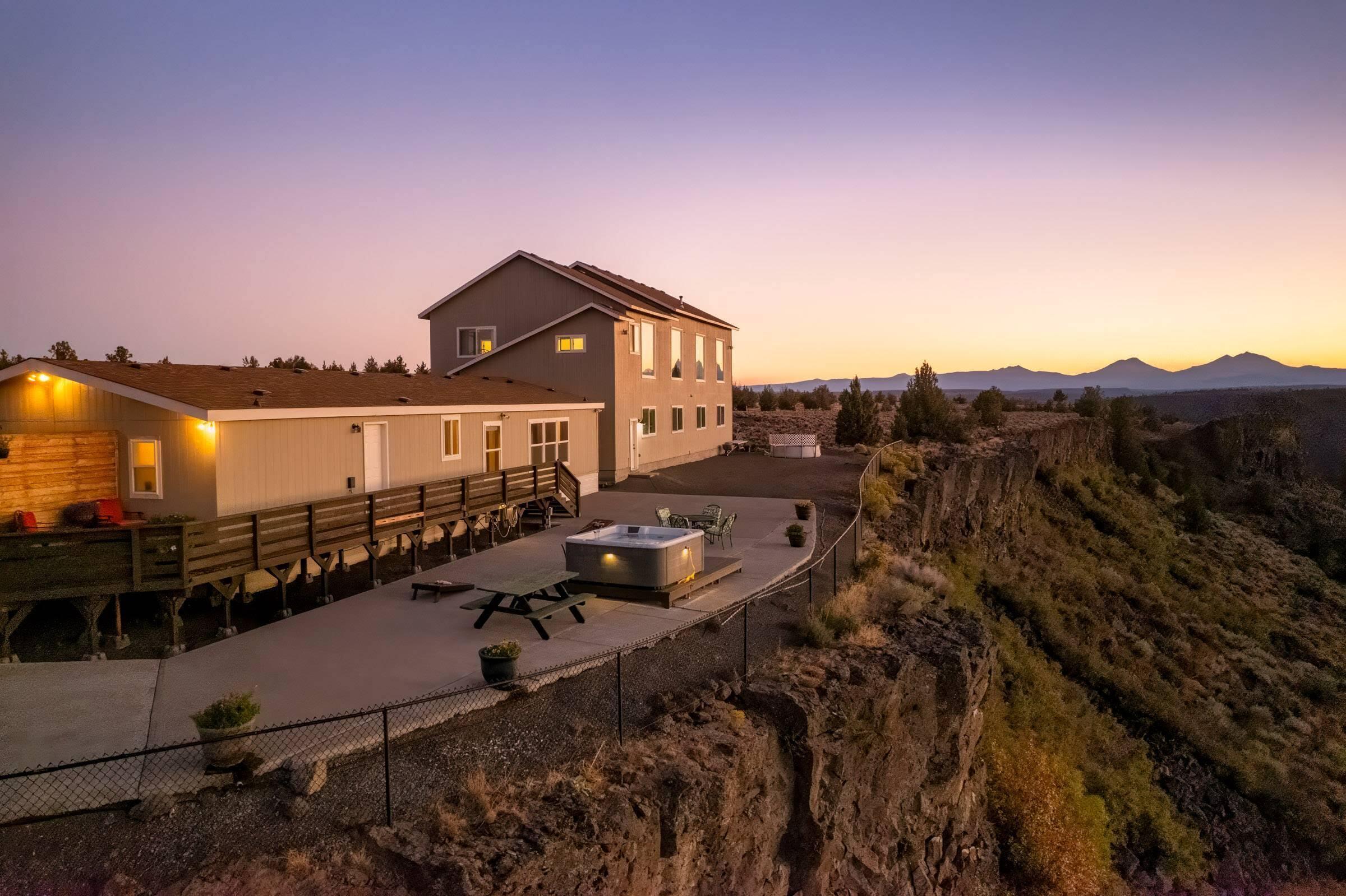 Best views in Central Oregon!! Situated on the rim of the Deschutes River Canyon, with panoramic and
unparalleled views from Mt Adams to Mt Bachelor, with the wild and scenic Deschutes River below, your
appreciation of Mother Nature will never waver. Besides the majestic view, this property offers elbow
room, at over 4 acres, and ample living space with over 3400 sq ft to call home. Perfectly setup for
multigenerational living or rental investment; a cozy 1620 sq ft manufactured home offering 3 Beds and
2 Baths, its own kitchen, expansive deck, hot tub and patio connects via interior breezeway to a 2nd
story living space with 2 Beds, 2 baths and a kitchenette. The upstairs living sits above an 1800 sq
ft, 4-bay garage, with one bay a dedicated workshop. Additional outbuildings offer more storage and
flexibility. Located in Crooked River Ranch, where recreation, community and vacation all call home.