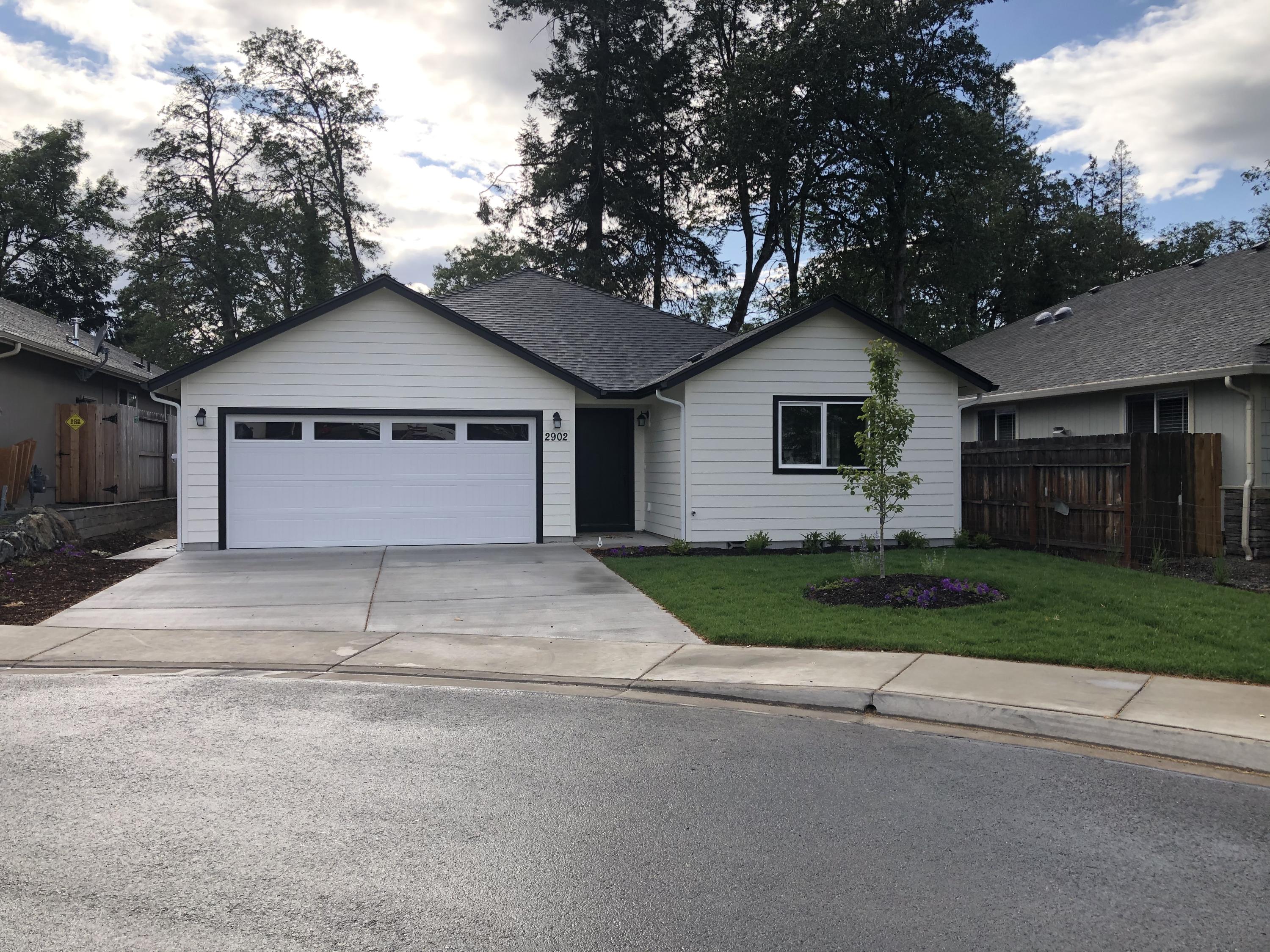 BRAND NEW house!!   The certificate of occupancy has already been issued - so  this home will be move in ready once escrow closes.   Have you been searching for a beautiful new home in Grants Pass with city services and schools?    This single story 3 bedroom 2 bathroom home on .21 of an acre in a nice, quiet cul-de-sac with a seasonal creek in the backyard is all of that and more!  The open floor plan with walk in closets and vaulted ceilings feels spacious and inviting - just waiting for your personal touches to transform this 2021 built house into your own HOME.