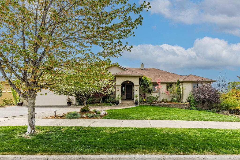 Custom built home in the prestigious Cherry Lane Estates! 5,448 sq ft home w/ 4 Bedrooms, an Office & 5 Bathrooms. 2 Garages w/ plenty of room to store a Boat & all of the toys w/ RV parking on a little over a 1/2 Acre. Relax in the Living room by the gas fireplace while enjoying the views. Formal & informal dining area. The Kitchen of your dreams includes plenty of cupboards & storage,6 Burner stove w/ Grill, Pot filler, High end appliances, Pantry, & Oversized Island that opens up into the Great room w/ beautiful custom Built-Ins. Outdoor entertaining on the Balcony w/ incredible Views. Main Level Primary Bedroom w/ large en suite, patio doors to the balcony, & walk in closet. Lovely En suite has a huge tiled shower w/ 3 shower heads & jets, soaking tub & water closet. An Office & full bathroom next to the Primary. Downstairs is a family room/Game Room w/ Wet bar, & 3 more Bedrooms that all have private Bathrooms. The patio leads out to the landscaped yard, garden beds, & fruit trees