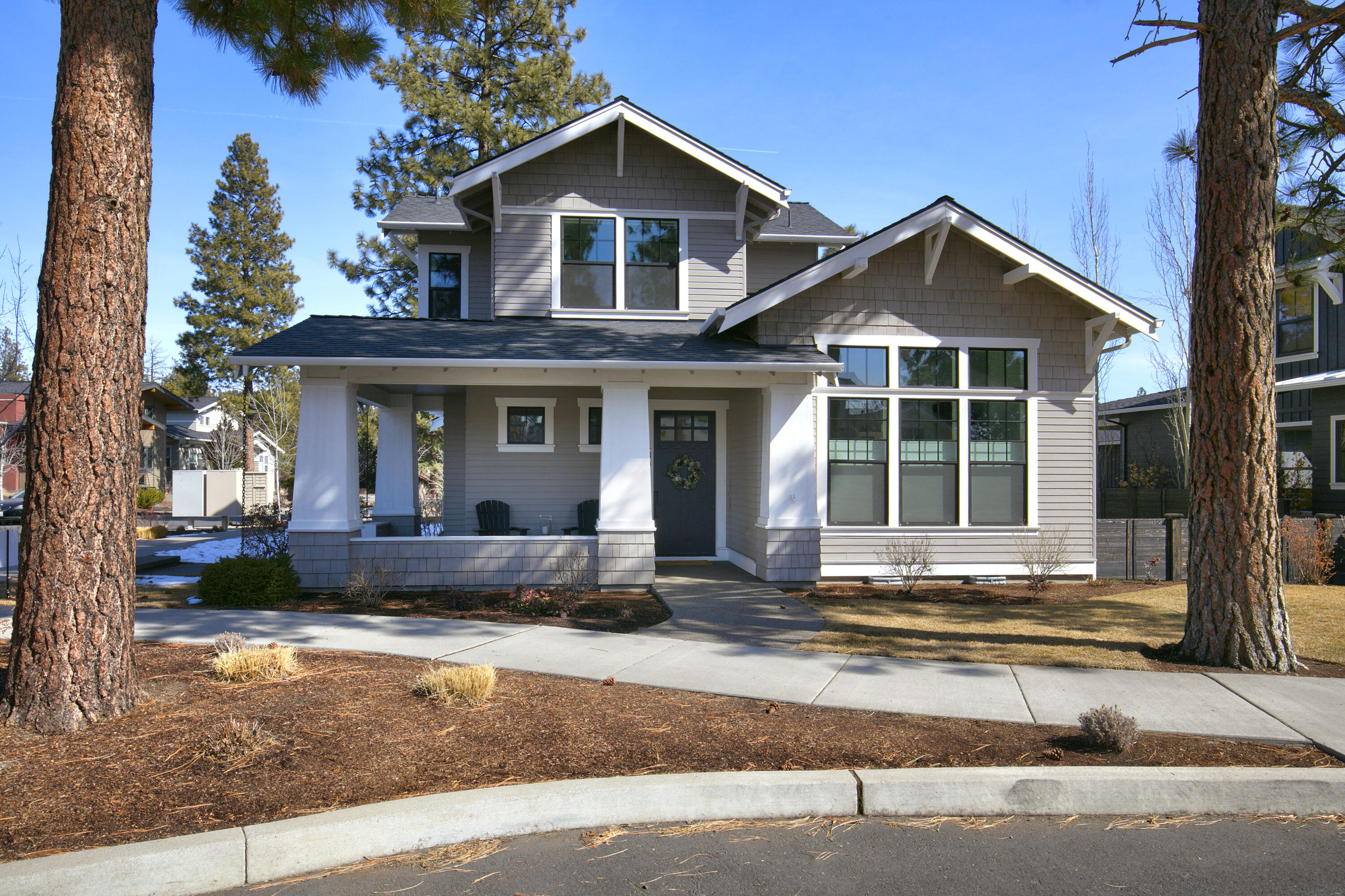 This former Tour of Homes champion, located just four houses away from Discovery Park, is impeccably maintained and boasts numerous amenities. Built by Structure Homes with a focus on energy efficiency. The main level hosts the primary bedroom, while the second floor features two additional bedrooms, a bathroom and a bonus loft with a bar area. The open kitchen boasts stone counters, a large pantry, and overlooks the living room with a fireplace, as well as the dining room with built-in buffet and double sliding doors leading to the covered patio complete with recessed lighting, skylights, a fan, and a television - ideal for year-round entertaining. Other notable features include triple pane window, dual opening cordless blinds, soft touch drawers throughout the entire home, a private corner lot, stunning hardwood floors, modern bathrooms with high vanities, heated marble floors in the primary bath. A powder room is conveniently located on the first floor. Wrap-around front porch!