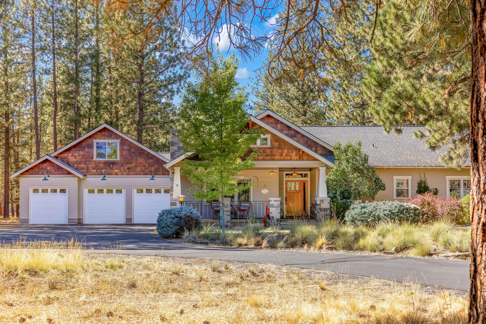 Custom-built, single-level home in the sought-after Sage Meadow neighborhood, backing USFS land for terrific privacy and forest views. The interior features hardwood floors in the main living areas, solid wood doors, and detailed woodwork throughout. The layout includes a living room, family room, and dedicated dining room with built-in hutch and bar. The large kitchen has a large island, granite countertops, stainless steel appliances, an eating bar, pantry, and ample storage. The primary suite offers deck access, a walk-in closet, a tiled walk-in shower, and a soaking tub. Exterior features: a 1,032 sq ft three-car garage includes a stairwell to a large storage area/bonus room (convertible with modifications); covered front porch, rear deck, or paver patio. fully fenced backyard with forest access gates; cement siding, a landscape shed, RV parking, a large paved driveway, and a blend of natural and manicured landscaping.
