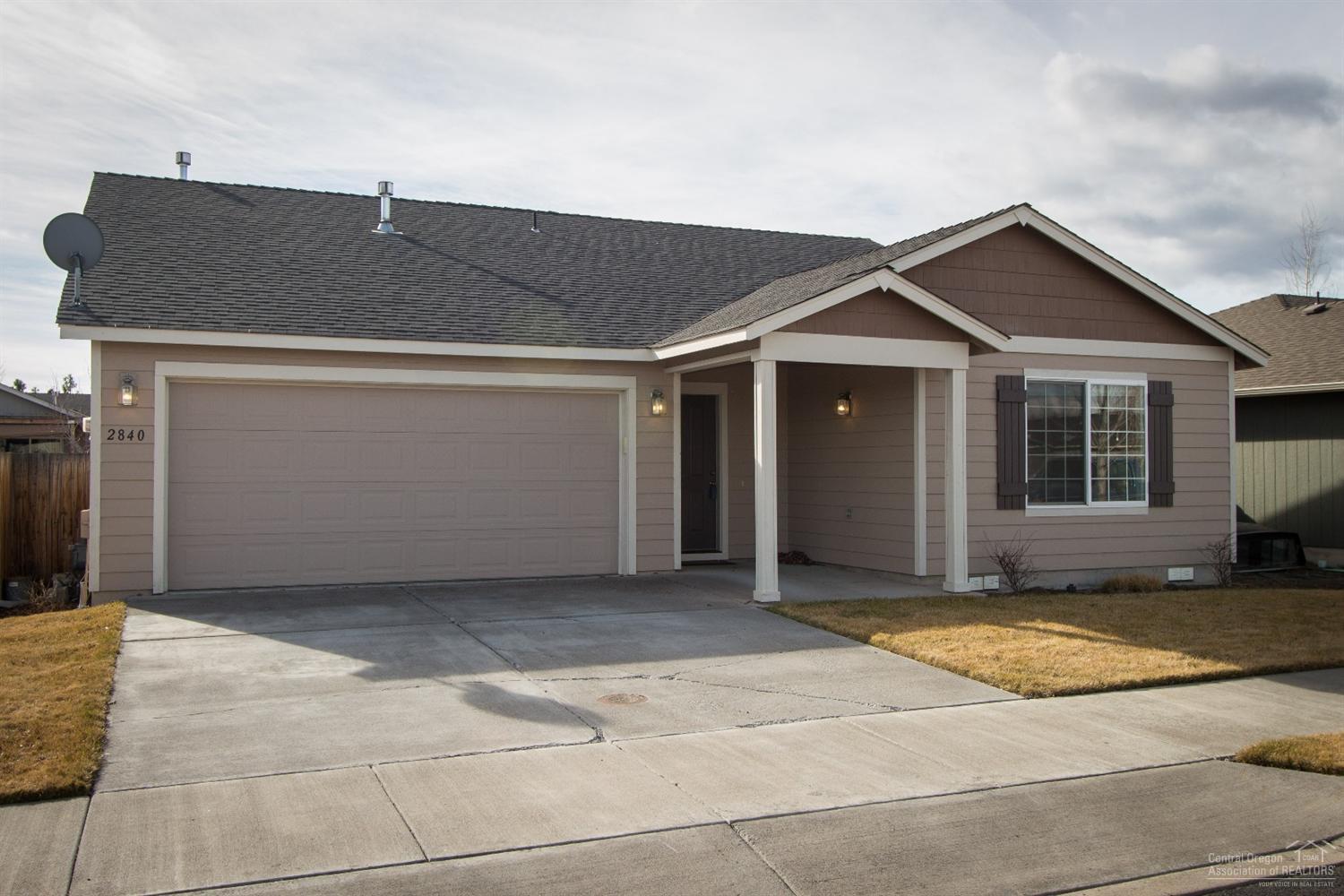 Attractive ranch style home with all the essentials in a quiet residential neighborhood several blocks north of Highland Ave. on the west side of Redmond. Deep covered entry, vaulted great room, island kitchen w/ breakfast bar. Wood flooring in DR and kitchen. Ceiling fans in great room and master BR. Slider in DR leads to paver patio in large fenced back yard. Wall cabinets in laundry room. Gravel pad for RV or boat parking inside gated fence beside double attached garage. W/D, refrigerator included.