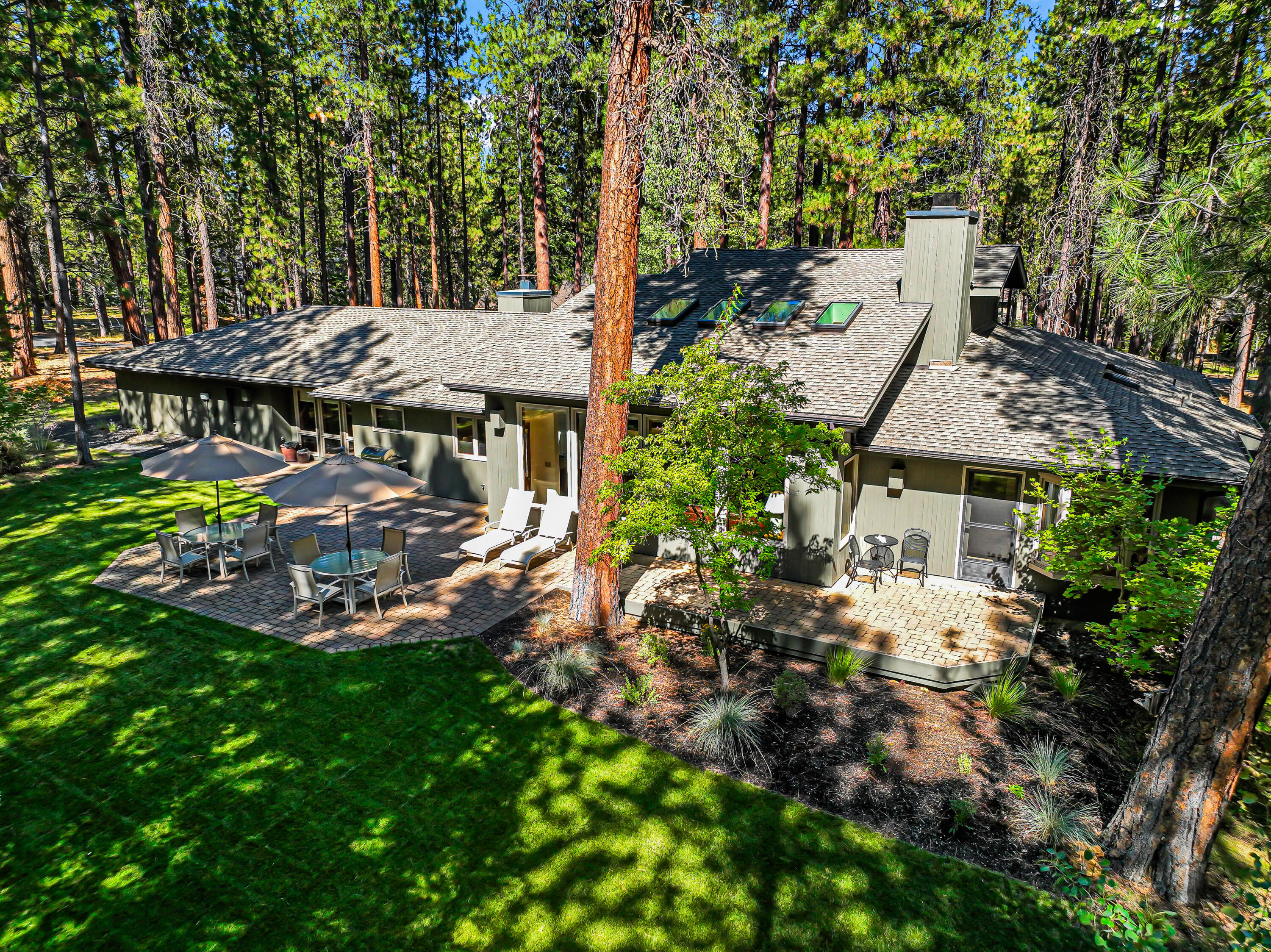 This beautifully landscaped home sits on over an acre with views of the 14th tee at the Glaze Meadow Golf Course and is just a block from the Upper Glaze Meadow Pool Complex. Designed for mostly single-level living, it features an open floor plan with a spacious kitchen, dining area, and great room with wood-burning fireplace. The main level includes three bedrooms, three full baths, a large family room, laundry, and flex space. Upstairs, a generous loft offers additional space for guests, entertaining, or relaxing. Outdoor highlights include a paver patio, sprinkler system, and paved driveway. Recent improvements include a new HVAC system (2021), new skylights, and fresh paint. Whether you're seeking a full-time residence or a peaceful vacation retreat, this home offers the perfect blend of comfort, space, and location in the desirable Black Butte Ranch community.