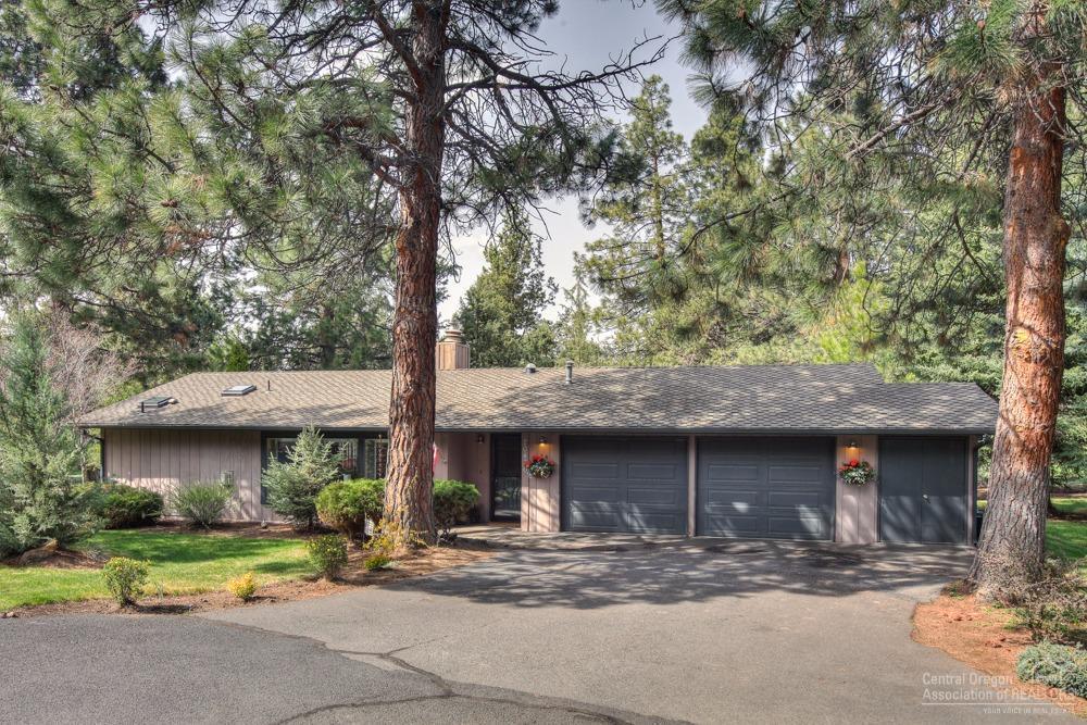Beautiful single level home in sought after Timber Ridge next to Bend Golf and Country Club. Private, lush setting with deer out your back door! Enjoy the large windows throughout with views to open green space or just relax on your spacious entertainment deck. Wonderful separation of master suite and 2 extra large bedrooms. Separate office w/custom built-ins, plus extra golf cart garage or shop. Private path to country club. Don't miss this one.