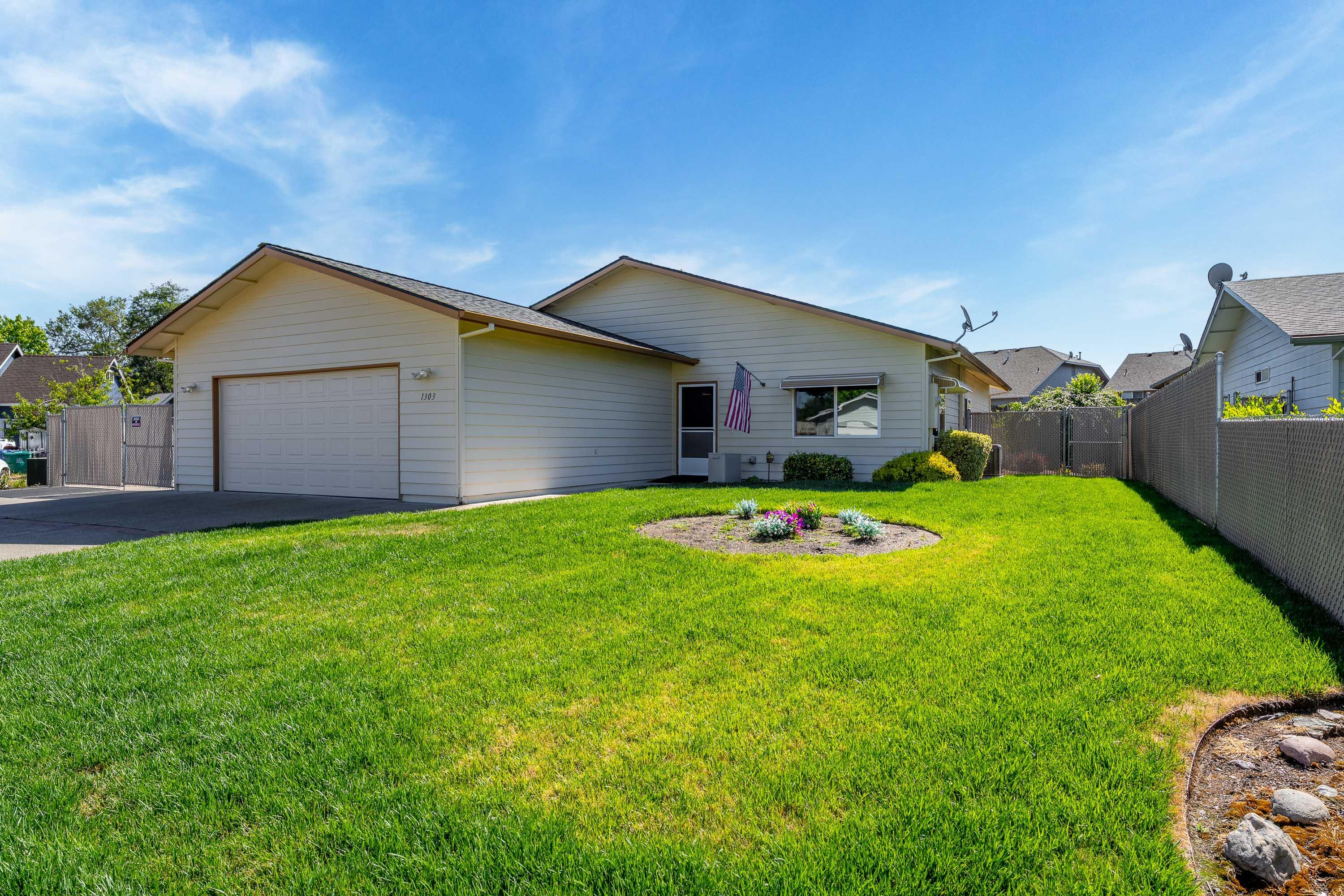 Immaculate 3 bedroom, 2 full bath home in the convenient Bluegrass Park Subdivision. Excellent care and maintenance inside and out!! This home was loved. FULL RV parking and hook-ups behind double swing gates. 2-car garage, with walk-in access from inside Garage + Double wide driveway in front for 3 cars. Covered Oversized back patio for alfresco dining or BBQ fun. Light, bright and cheerful throughout. Kitchen is organized with laminate countertops and easy care floors. Schools, shopping, bus lines and entertainment nearby. Roof is newer, exterior paint is in GOOD condition. GPID water rights for your lush garden or garden boxes and fruit trees. Elevated deck in the rear yard for garden boxes. MOVE IN READY. Don't miss scheduling your tour today.