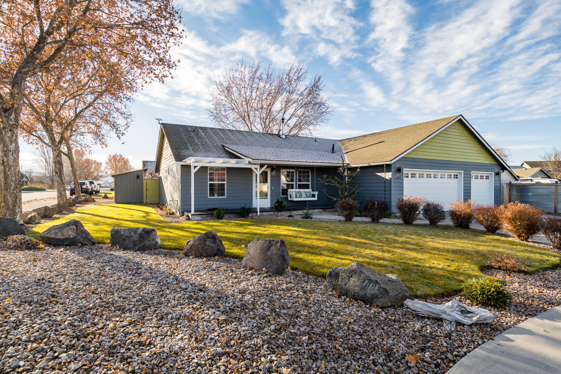 Situated on a corner lot in a quiet cul-de-sac within the desirable Stoneridge Subdivision, this well-maintained single-level home offers comfortable, functional living with custom updates throughout. The open living area features vaulted ceilings and a new wood-burning stove, creating a warm and inviting centerpiece. The updated kitchen includes custom cabinetry, butcher block counters, a hammered copper farmhouse sink, glass tile backsplash, and a gas range, with all appliances included. The primary suite offers a private retreat with direct access to a secluded hot tub patio, perfect for relaxing year-round. Outside, enjoy a fully fenced backyard with in-ground sprinklers, a built-in outdoor BBQ, and RV parking behind a well-built metal swinging gate with remote opener. A spacious three-car garage provides excellent storage and workspace with a workbench, laundry sink, and custom utility cabinetry. Tankless water heater and formal dining area complete this exceptional home.