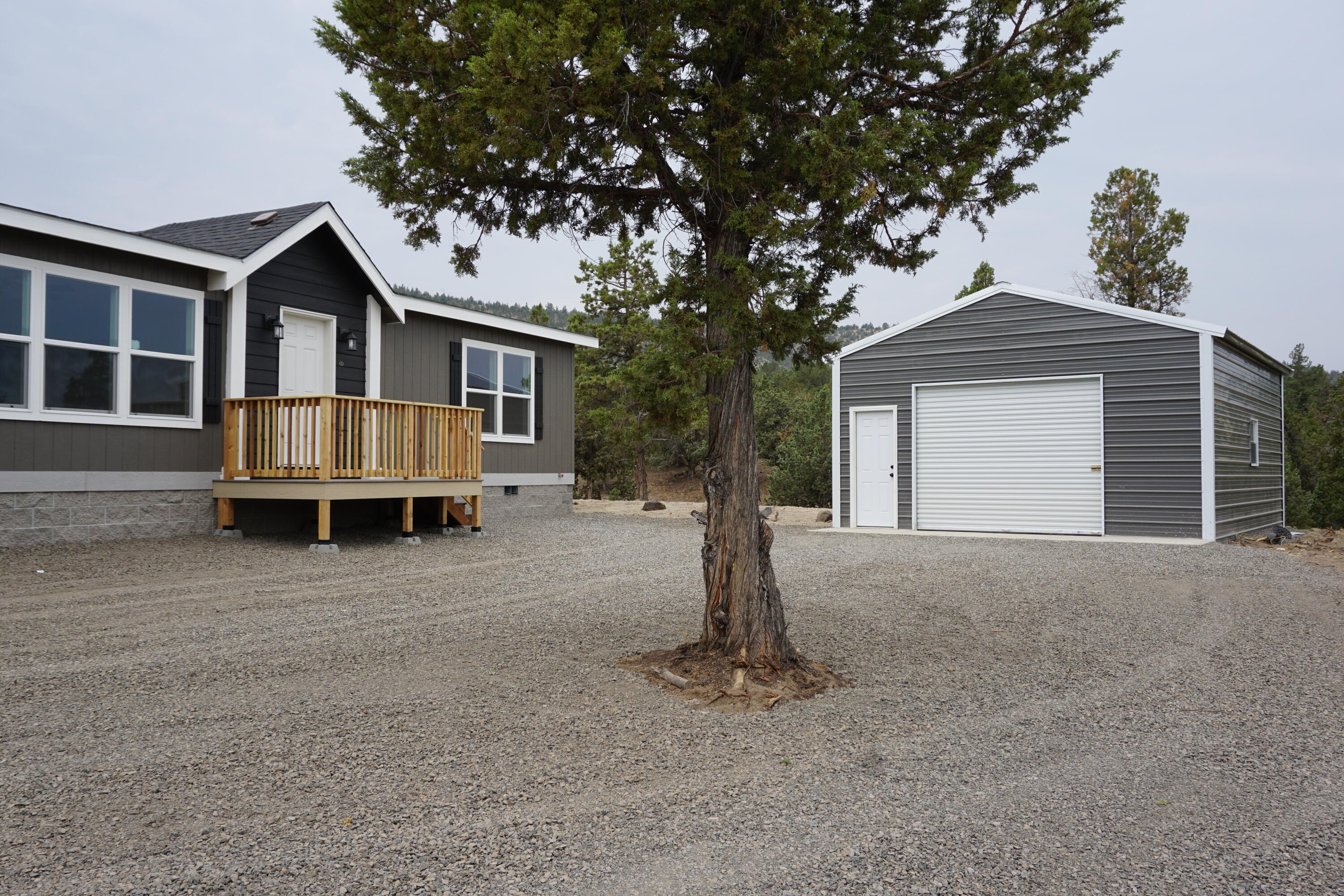 Superb setting in The Highlands Subdivision! This Brand New manufactured home sits on 1.25 acres, and features an open floor plan with 3 bed, 2 bath, oversized laundry room w/ walk in pantry equipped with shelving and a dedicated outlet for an extra refrigerator/freezer, Primary bedroom separation, and Walk in closets through-out all 3 bedrooms! Primary bath has double sinks, walk in shower, and linen shelving. Walk into the open living room and Large kitchen with bar/island, and slider off the dining room. Both the living & Primary room come equipped with Ceiling fans and wall mounted tv outlets. Outside features a Beautiful Trex decking entry, a 20x25 Metal Shop/detached garage with a concrete slab and apron, Frost free spigot and water stub for future irrigation, and a Trex Deck outback. HOA dues cover snow removal & road maintenance. Approx 10 min to town or 15 min to the Prineville Reservoir, don't miss this one!!