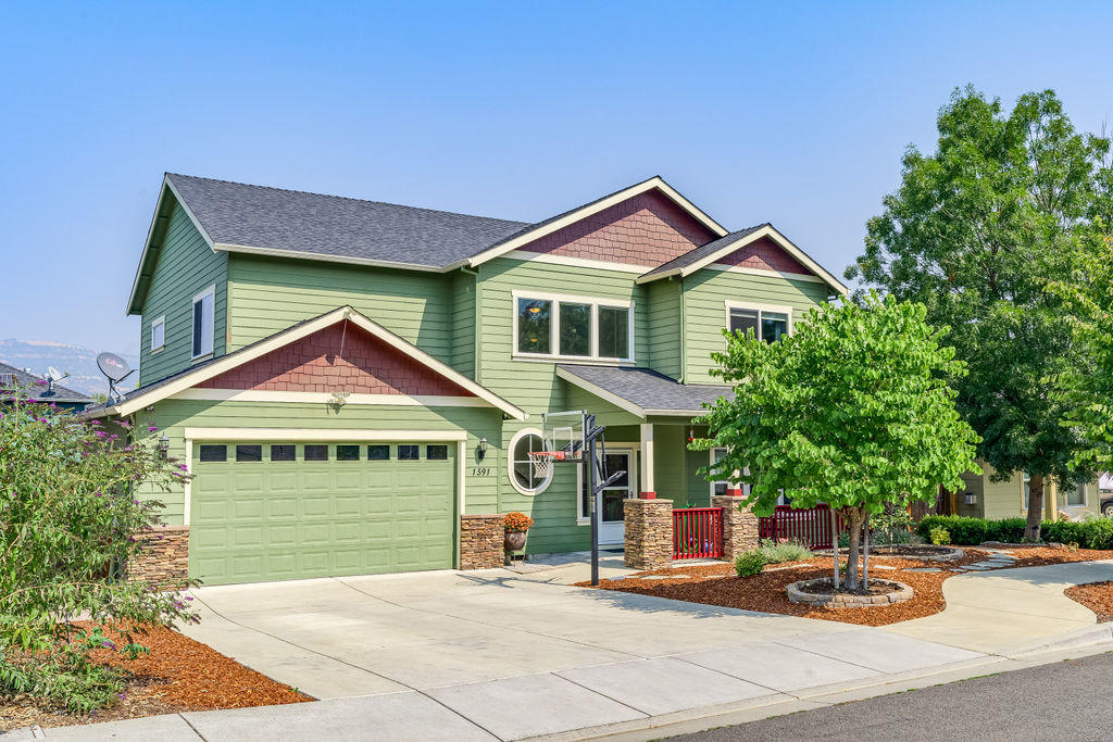 Gorgeous, custom built family home located on the South end of Talent, in a sought after neighborhood. Quality materials throughout including extensive tile flooring, custom Cherry cabinetry, slab granite countertops in the kitchen and bathrooms and stainless appliances. Versatile and functional floorplan features a light filled living room as well as a cozy family room with a gas fireplace. Open kitchen with informal nook, breakfast bar and adjacent formal dining room. All four bedrooms are oversized and located on the second level. Gorgeous master suite has a spacious walk in closet, beautifully tiled bathroom with dual vanities, corner soaking tub and a large tiled shower. There is incredible storage throughout the home and garage. Laundry sink, pantry storage and central vac. Lovely covered patios in the front and rear yards. Conveniently located dog run with access from the interior. Views of Grizzly Peak.