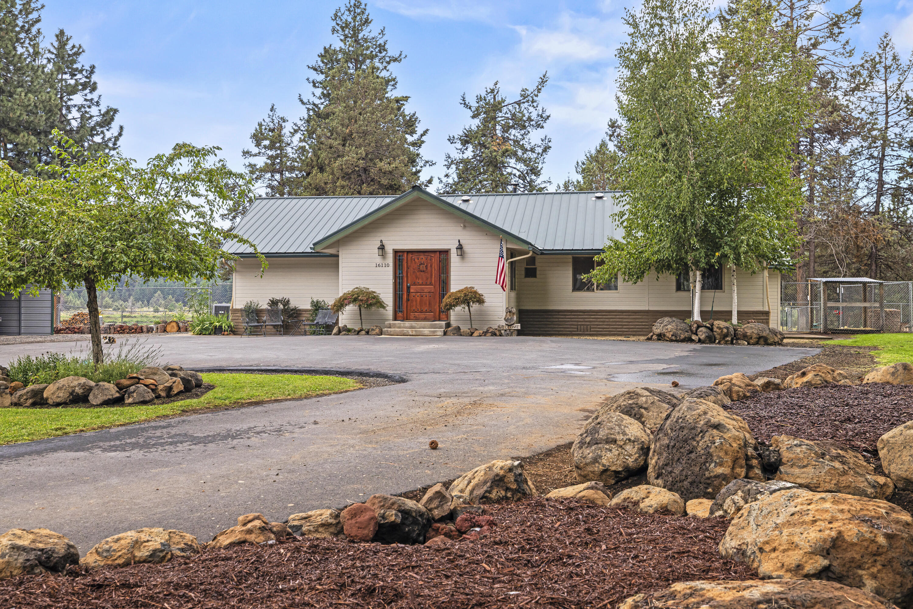 Beautiful 3 bedroom 2 1/2 bath home in Keno on over an acre with river views and multiple SHOPS!!. This home is a must see with so much to offer including a beautiful tile entryway leading to the spacious updated kitchen with island, stainless appliances and recessed lighting; living room with a beautiful rock fireplace and rustic vaulted ceilings; dining room; office with outside entrance; primary bedroom with slider out to the deck, bathroom w/large walk-in glass shower and cedar lined closet; home has beautiful flooring and exposed beams throughout; and attached 2 car garage. Outside, this property features a 50x30 heated shop with 220 w/two rollup doors; second smaller shop w/rollup door, detached garage, storage/bonus building all are plumbed for gas; RV/Equipment Cover; and property is fenced with a gate entrance. Two covered gazebos, large tile patio, beautiful landscaping, garden area, raised beds, inground sprinklers and river views add to the peacefulness of this property.