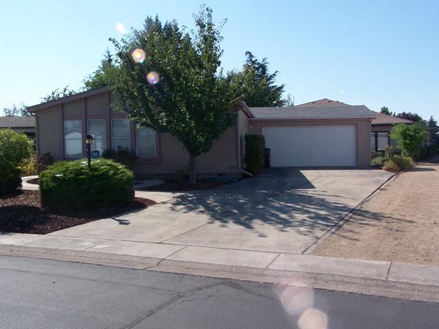 It's a lifestyle - The Meadows 55+ community. 2 bedroom, 2 bath Golden West with extensive oak cabinetry. Vaulted ceilings in living room, separate dining area with mirrored hutch, large kitchen with lots of cabinets, cook top, wall oven, pantry, and breakfast bar. Bonus area for dining, den, for family room. Indoor laundry with deep utility sink. Garden area in back corner. Close to community meeting facility. The Meadows also includes ingrown pool, spa/sauna/hot tub, weight room, library, billiards, and much more. $97 a month association dues including garbage and sewer. Come enjoy what this home and neighborhood has to offer.