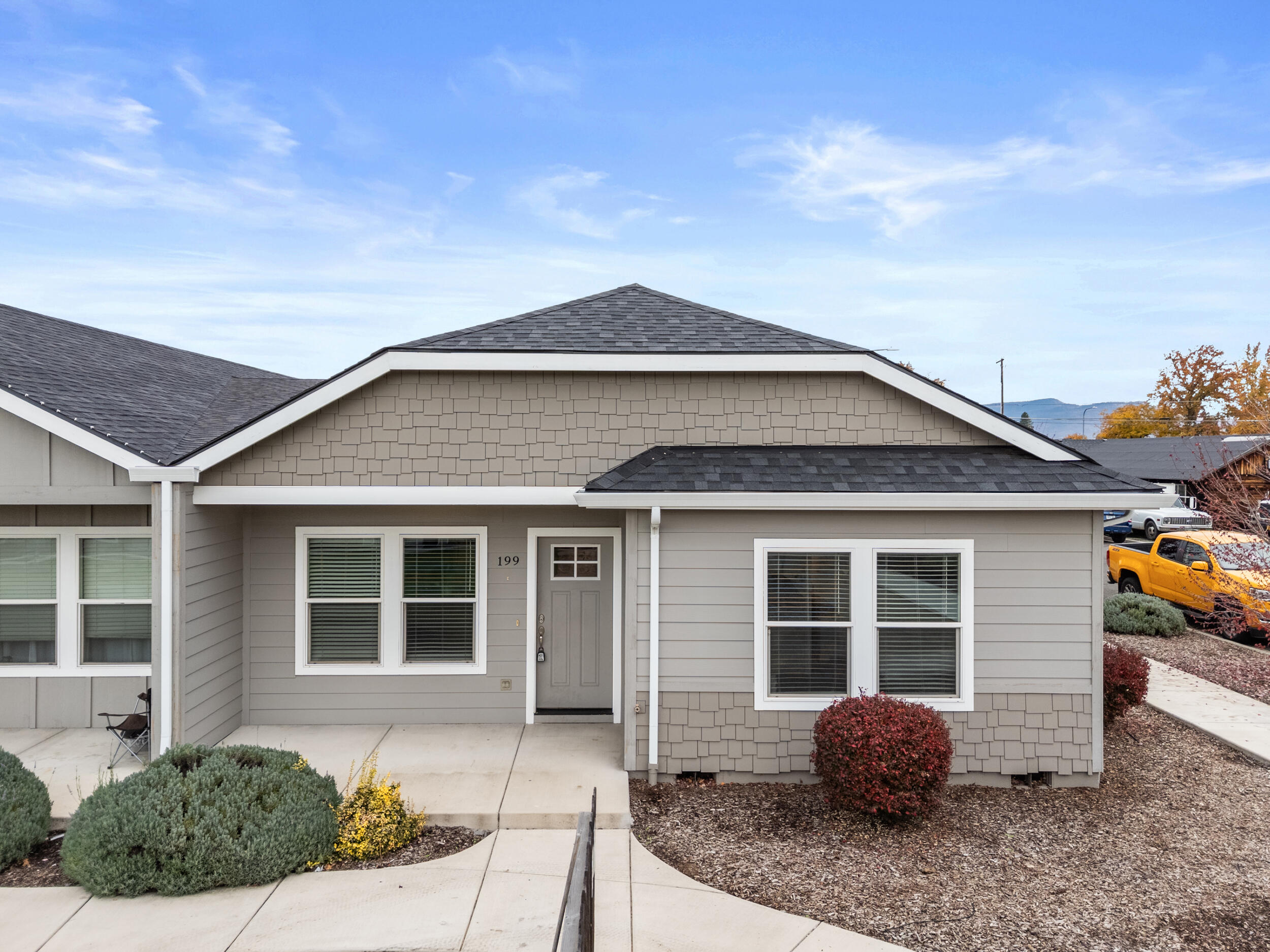 Beautifully built in 2019, this modern Medford home offers over 1,400 sq.ft. of stylish living space, featuring 3 bedrooms and 2 bathrooms. The open floor plan with vaulted ceilings creates an inviting atmosphere, perfect for entertaining. The kitchen features a large island, granite countertops, stainless steel appliances, and a walk-in pantry, making it ideal for any home chef. The spacious primary suite features a walk-in closet and a private en-suite bathroom with a sleek walk-in shower. Gorgeous finishes, laminate flooring, and an abundance of natural light enhance the home's modern charm. Complete with a 2-car garage and low maintenance yard, this move in ready gem combines comfort, functionality, and timeless design for its next proud owner.