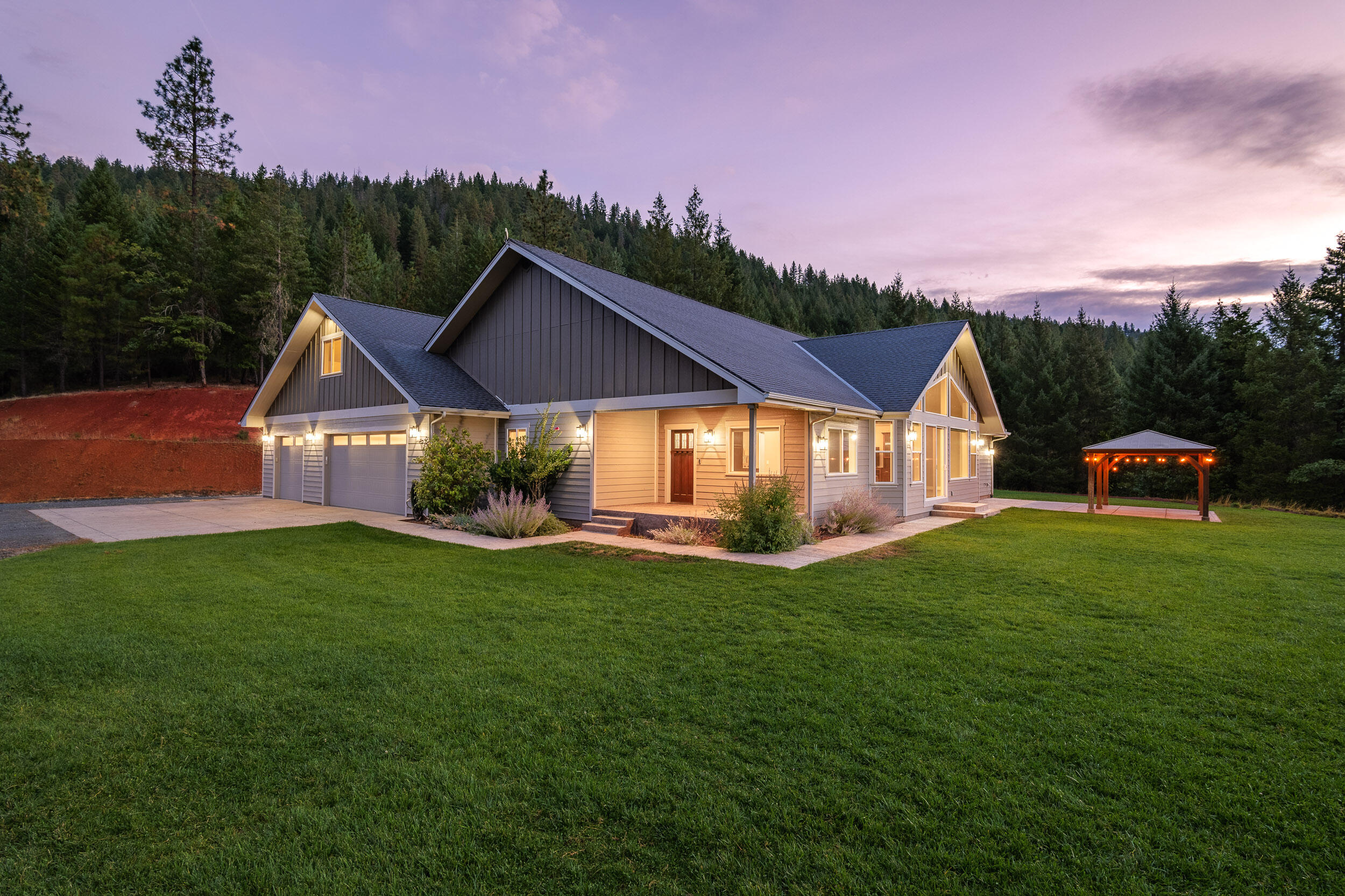 Discover unmatched luxury, privacy, and opportunity at this custom-built estate on 80.7 acres in the heart of Southern Oregon. The 3,321 SqFt main home features 4 bedrooms and 3 baths, high-end finishes, vaulted ceilings, and a chef's kitchen with premium quartzite countertops, top-tier appliances, and a spacious island. Retreat to the expansive primary suite with a spa-inspired bath, including a freestanding soaking tub and steam shower. The additional 1,288 SqFt guest house offers 2 bedrooms and 1 bath, with heated concrete floors and modern conveniences. Outdoors, enjoy breathtaking views, serene hiking trails, and direct access to over 400 acres of BLM land. Designed for those who crave both luxury and adventure, this property offers space, seclusion, and modern amenities in a pristine natural setting. Perfect for multi-generational living, entertaining, or as a peaceful retreat, 112 Carmel Drive is the epitome of elegance in the Rogue Valley.