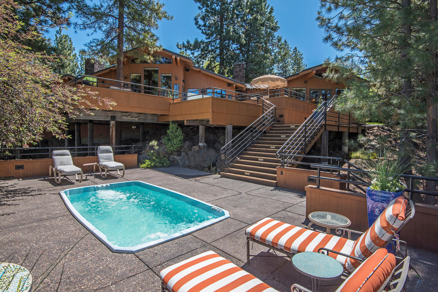 An exquisite home with a gourmet kitchen featuring a custom island topped chiseled edge granite, two Sub zero's, two dishwashers, Wolf gas range with a custom handmade copper range hood. All this is open to the great room all of which has outstanding views to your favorite Cascade peaks, black walnut hardwood flooring, hand selected wood beam accents throughout, a Central Oregon inspired rock fireplace. The bonus room has its own stone fireplace and is currently used as an office; this room would easily make a fantastic family space. Each bedroom is appointed as a complete suite. The multi tiered west facing decks make for inspiring outdoor living. Hit the swim spa/lap pool before dipping into the hot tub to soak while taking in the sunset. For all of your Bend lifestyle toys there are 2 detached garages, an oversized three car plus with finished space above that can be used as an office or studio & a standard two car garage which possibly could be converted to a casita/ADU.