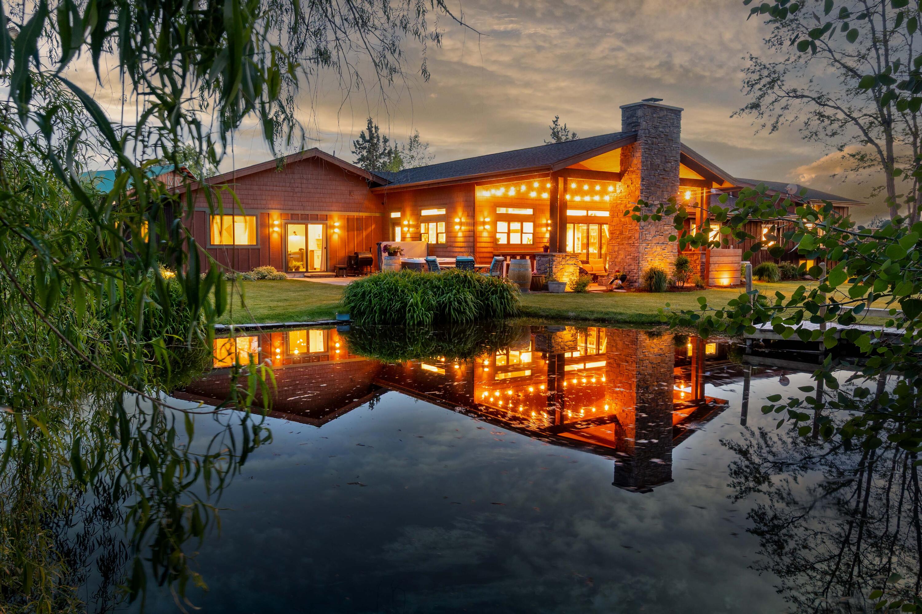 Discover peace, privacy, and panoramic Cascade Mountain views--where eagles soar, deer roam, and the city feels far away. Nestled on 4.23 acres—with 1.5 acres of COI irrigation, this fully renovated 5-bed, 3-bath home offers 3,653 sq. ft. of refined living space. The heart of the home is the sunshine streamed open-concept gourmet kitchen with high-end appliances, large pantry, and seamless flow to the covered patio and BBQ area. Ideal for multi-generational living or remote work with 2 living rooms, bonus room, and office. Relax on the wraparound deck, enjoy the fireplace by the pond, or explore the custom treehouse. The 30'x40' heated shop has an office, tack room, and trailer turnaround. The property includes a fenced garden, greenhouse, chicken coop, corral and paddock. Convenience and ease with an underground pressurized irrigation system in the front pasture and a second pond with in-ground irrigation for the back field. A rare blend of rural charm and luxury living—welcome home!