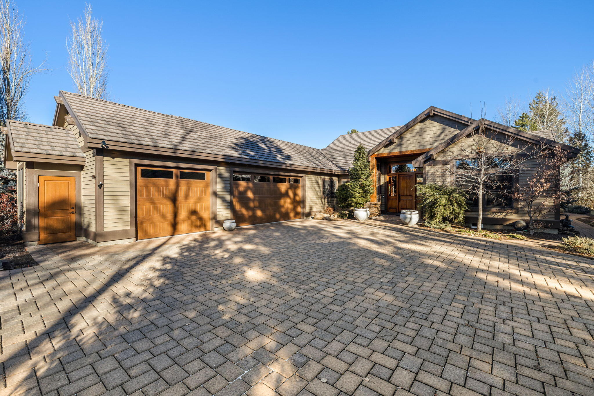 Single Level Broken Top custom home on private .45 acre property situated along the 9th fairway.  The curb appeal of the elegant paver drive & mature landscaping, sets the stage for what lies beyond.  Arranged on one level, the flowing floor plan is the ideal layout for day to day living & entertaining friends and family. The welcoming great room creates a comfortable space that transitions easily to the spacious dining area, chef's kitchen & garden view breakfast nook. The primary suite is in a separate wing from the two full-ensuite guest rooms & features private access to patio, as well as a cozy reading nook and gas fireplace. Outdoor entertaining is a dream on the large paver patio, a serene space that includes a fabulous Pergola enclosed outdoor kitchen with bar seating, granite counters, built-in gas grill, porch swing & solar powered louvered covering allowing you and your guests to enjoy sun or shade. There is also a huge 3 car garage w/ plenty of room for your outdoor gear.