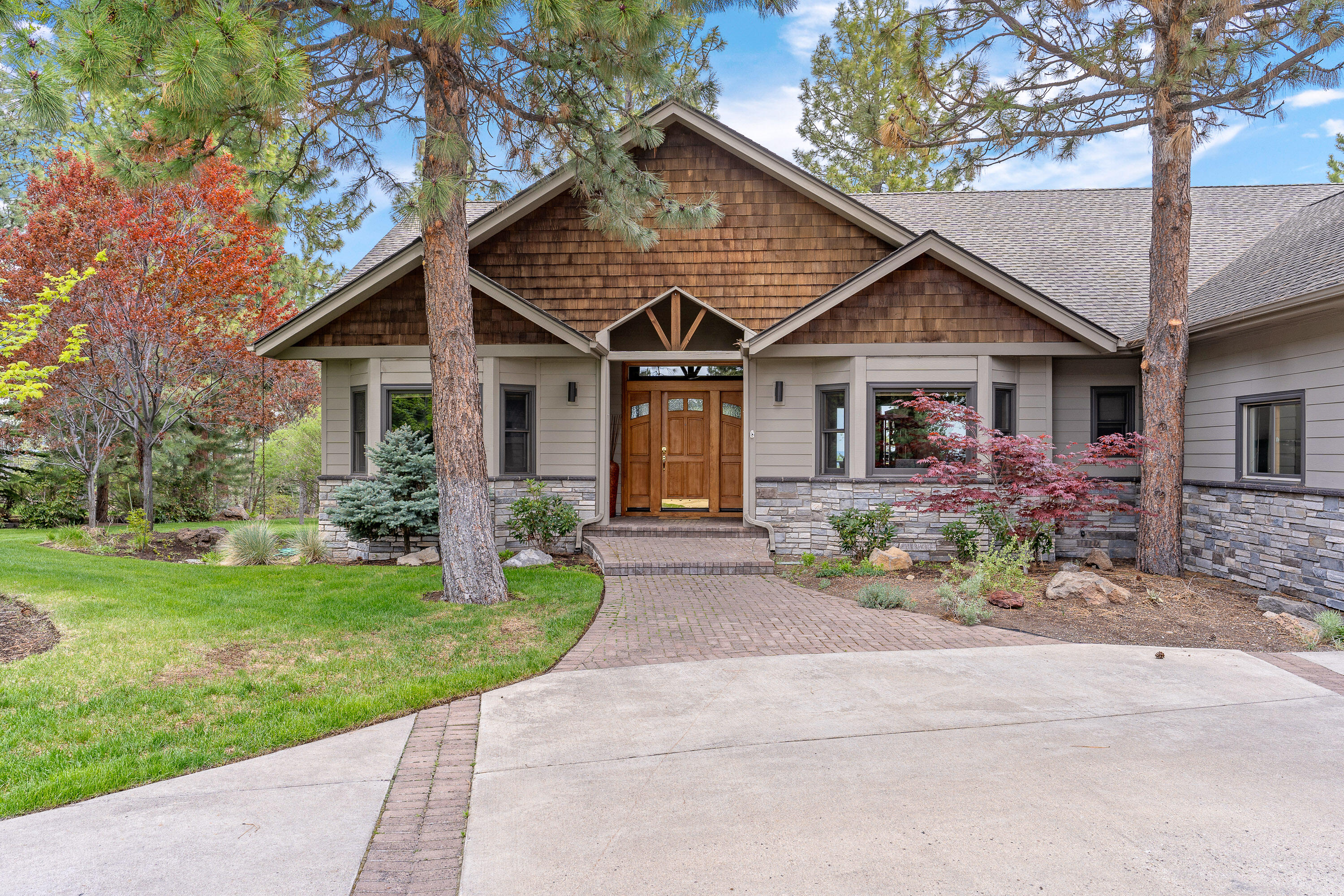Remarkable NW contemporary home boasts 3441 sq ft of living space, with 2987 sq ft on the main level & a 454 sq ft bonus room. Offering 3 bedrooms, 2 full baths & 2 half baths, providing ample space for comfortable living. Main level features;  large great room, perfect for enjoying the serene surroundings, a spacious office & formal dining room.  The kitchen is a chef's dream, equipped with double ovens, granite and quartz countertops, a wine refrigerator & casual dining area. The primary bedroom boasts a luxurious ensuite bathroom, providing a private retreat within the home.  Step outside to discover the outdoor oasis, featuring Trex decking spanning 1111 sq ft &1875 sq ft of concrete-paved area, built-in BBQ, hot tub, creating the perfect setting for relaxation & entertainment.  Other features include a three-car garage, flat driveway, in a private forest setting with stunning views of Mt Jefferson & Mt Hood, situated on .71 acres offering unparalleled tranquility and serenity.