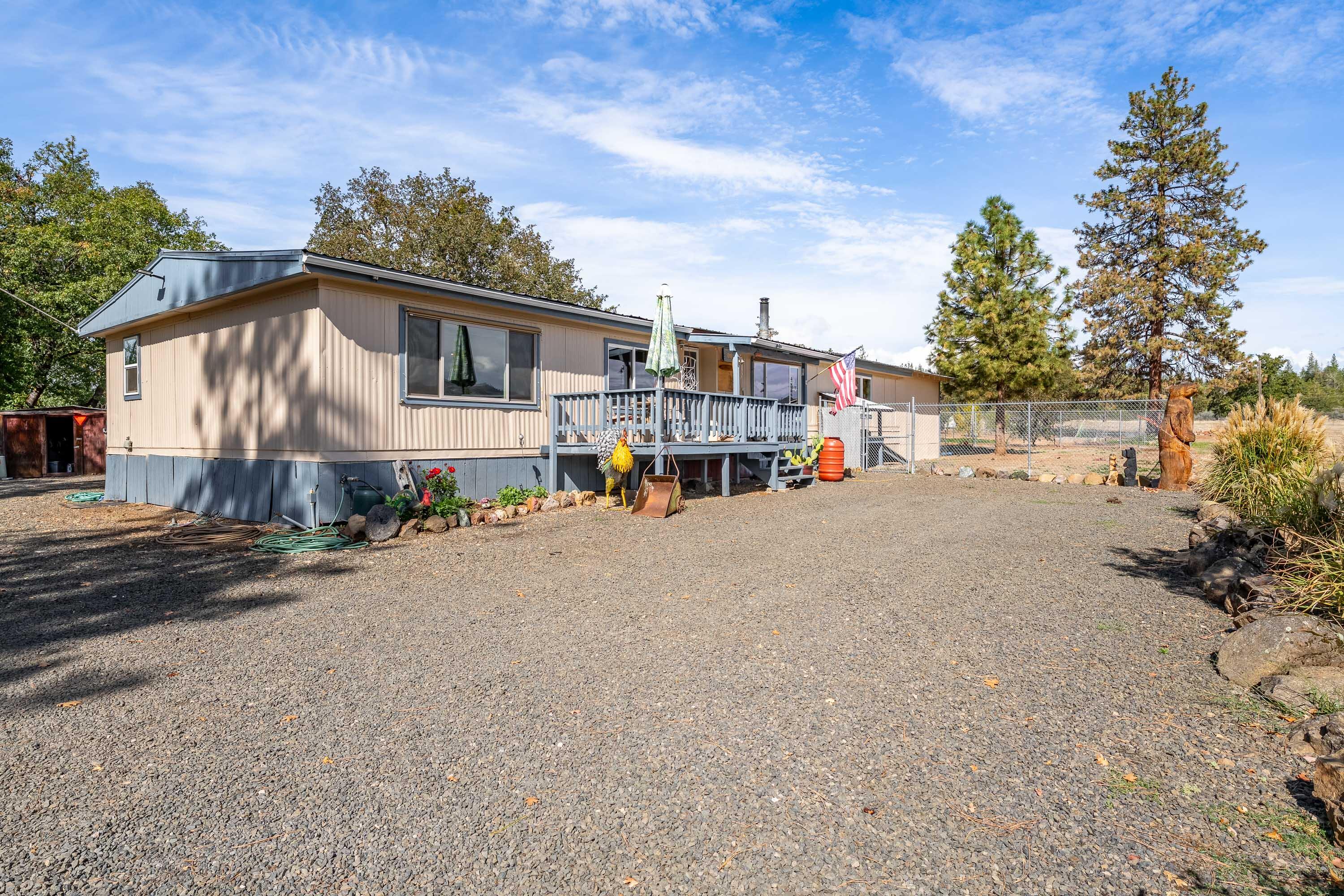 Remarkable Country Home. 5 Bedrooms, 2 Bath, 2,025SF 1978 Manufactured Home with a 1984 Permitted Wood Frame Addition that added 2-bedrooms. 2-car garage, Granite kitchen counter tops, & Marble Tile Showers. 1-254SF Cabin that could be an ADU, 2-wells, Greenhouse, pasture, Pump-house & 2-2,500 gal water water storage tanks. Storage Tanks do not reflect well production. 4-Above Ground Fuel Stations. Above Ground Pool for fun filled days. Fenced dog run w/dog houses. Property is Fully fenced with an electric sliding driveway gate. Dry heat Sauna & Spa on covered back porch for evenings under the stars. Stone patio & BBQ area. Propane service. Central Heat & Air. Fruit Trees; Peach, Plum, 2-types of Cherry, 4-types of Apple. Garden supplemented with a high grade soil installation. All remodel work done with exceptional care. Covered RV parking.  Storage sheds. Exceptional quality. Don't miss seeing this home. If you are looking for a mini farm or just a Quality Country Home this is it!