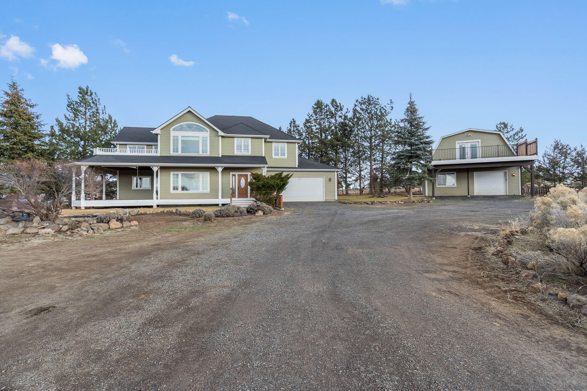 Cascade Mountain Range views, privacy, & unmatched versatility on 2.5 fully fenced acres—minutes from Bend in the coveted ''Golden Triangle'' of Bend/Tumalo. This exceptional estate offers rare multi-generational living & income potential, featuring a 2,599 sqft custom home with 3BD, 2.5BTH, vaulted ceilings, bonus loft, wood-burning stone fireplace, gas fireplace, & an upper deck with hot tub overlooking the mountain views. Primary suite boasts a spa-like bath with heated travertine floors, jetted tub, & walk-in tile shower. Fully permitted 2BD guest house with full kitchen, laundry, deck, & garage adds flexibility for guests, extended family, or rental use. Hobbyists will love the 30'x40' shop with 200-amp service, 220V hookup, & bathroom. Property includes a greenhouse, irrigated garden with deer fencing, chicken coop, wood storage, & is wired for a backup generator. All buildings painted in 2024. A rare opportunity in Central Oregon - offered at an exceptional value!