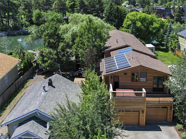 Amazing home built in 2008 & remodeled in 2012, sits right on the river across from Columbia Park. Home includes 2 master suites (1 up, 1 down), 2 offices, upstairs & downstairs laundry, media rm w/black out curtains & blinds, bonus rm w/separate full size built in fridge & dishwasher, radiant floor heat, concrete floors on the main level w/hickory hardwood floors upstairs. All surfaces are custom concrete counter tops w/the exception of the full bath down. Home has a solar voltaic & solar hot water system.